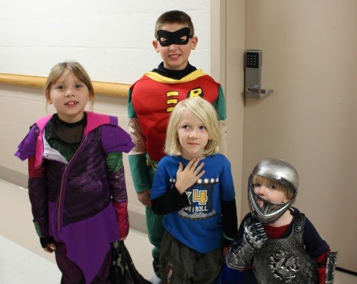 Eager trick-or-treaters gather to show off their costumes.