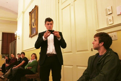 Flinn attempts to try and find an app on an audience members phone