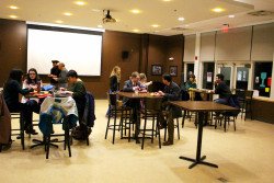 Students and faculty converse as they eat.