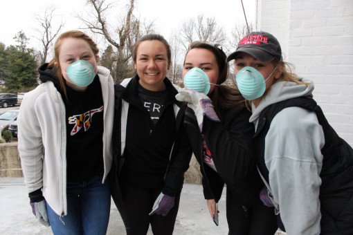 These students are masked up and ready to patch up the Armory's paintjob.
