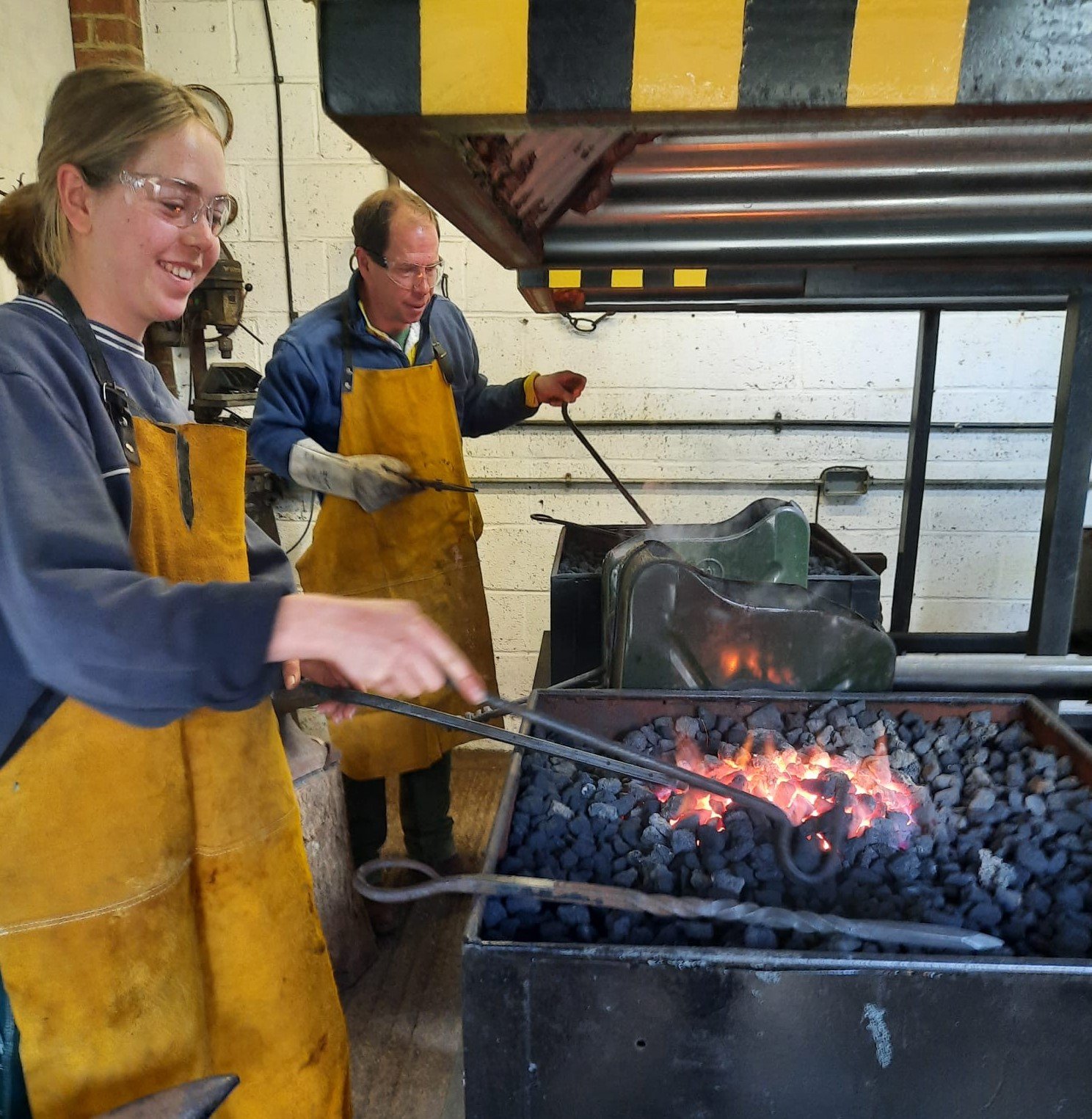Students forging a toasting fork