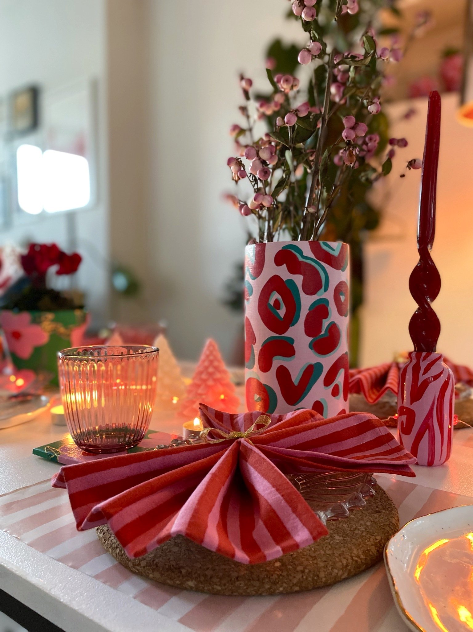 Christmas table set up with leopard print cylinder vase