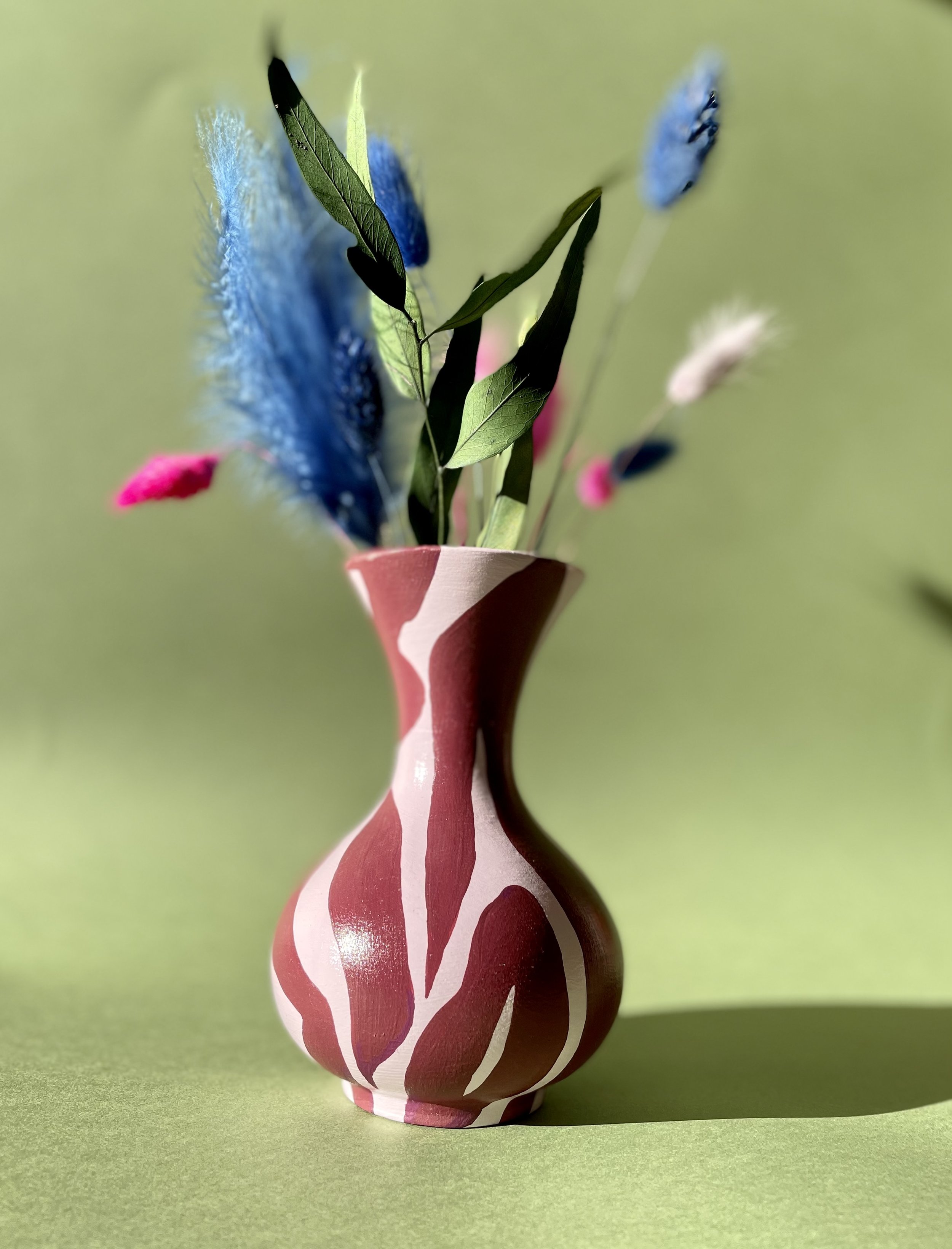 pink zebra print flue vase with dried flowers
