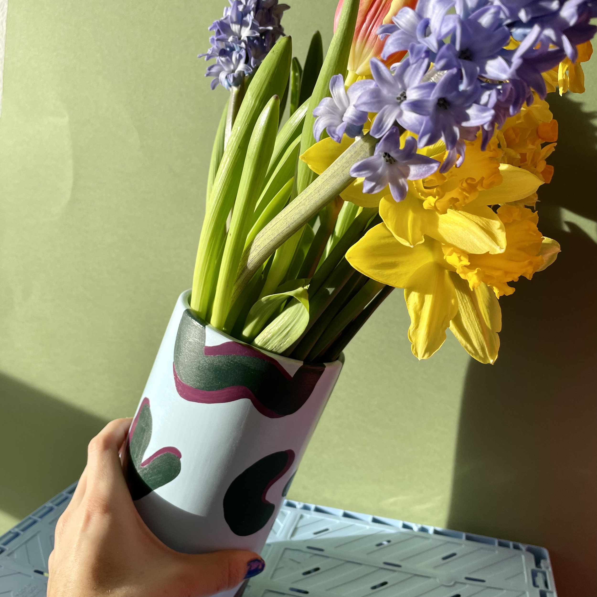colourful spring flowers inside a large cylinder vase