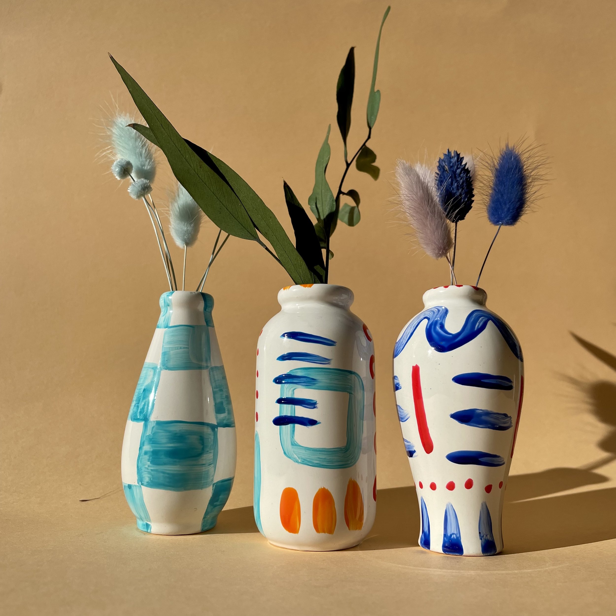 colourful vases with dried flowers