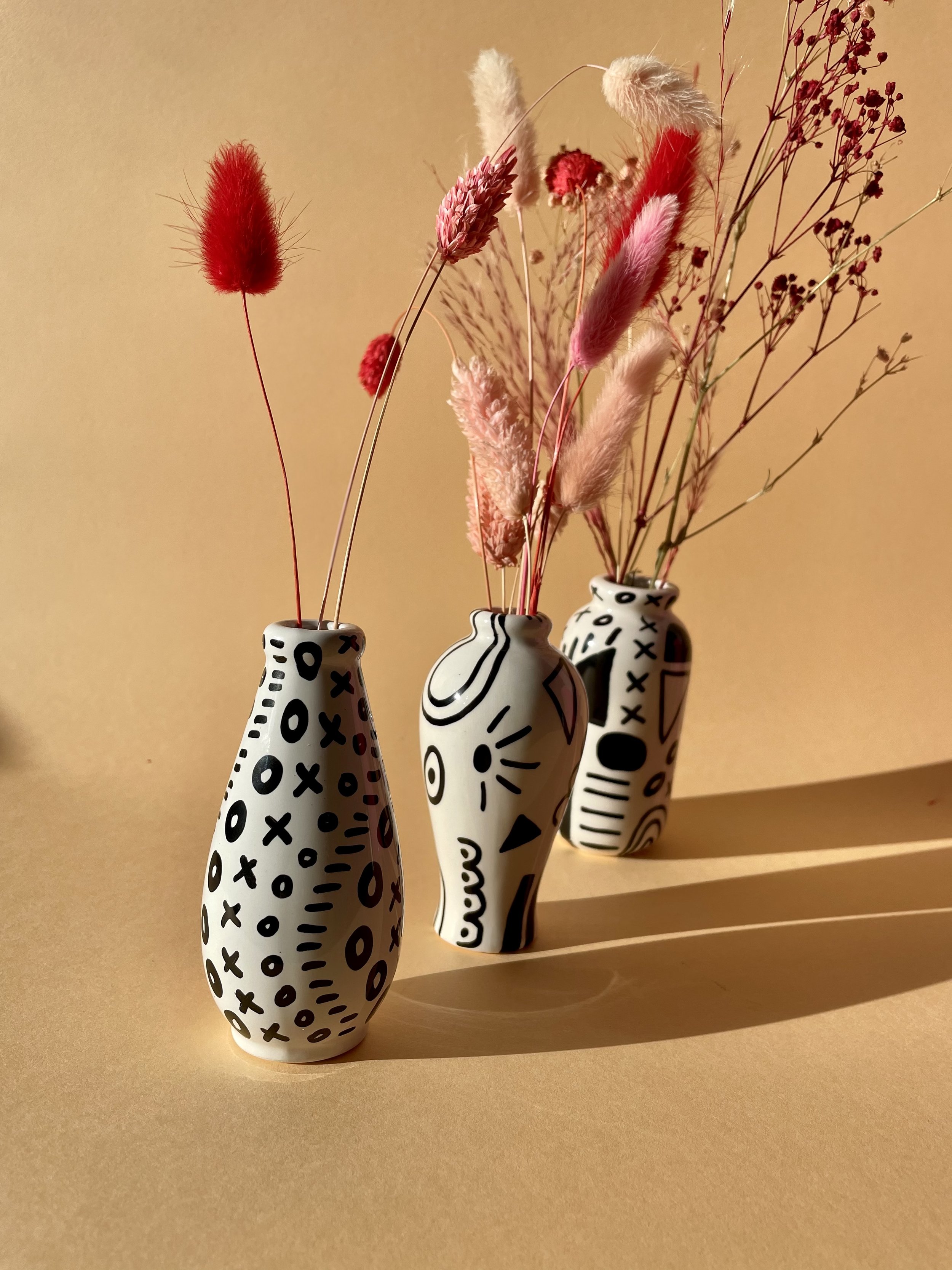 monochrome stem vases with dried flowers