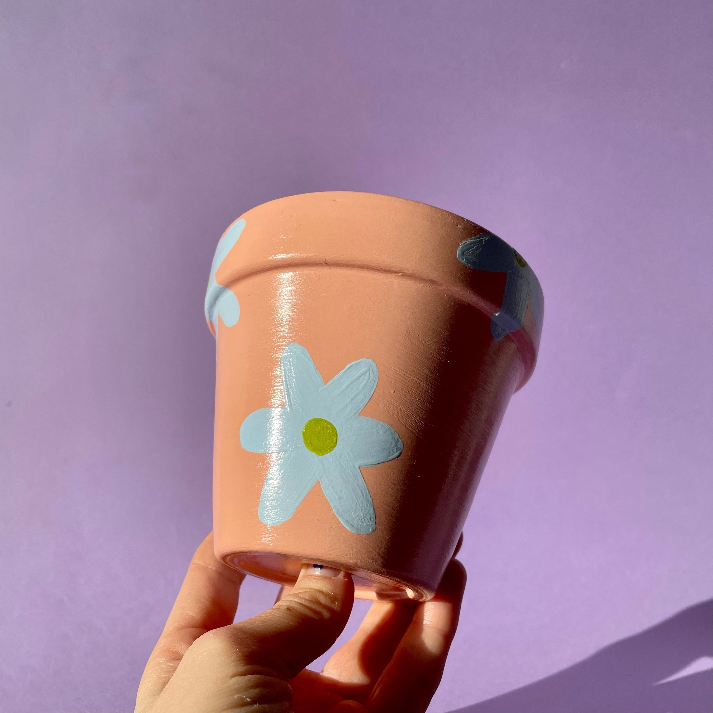 peach plant pot with sky blue and green flowers