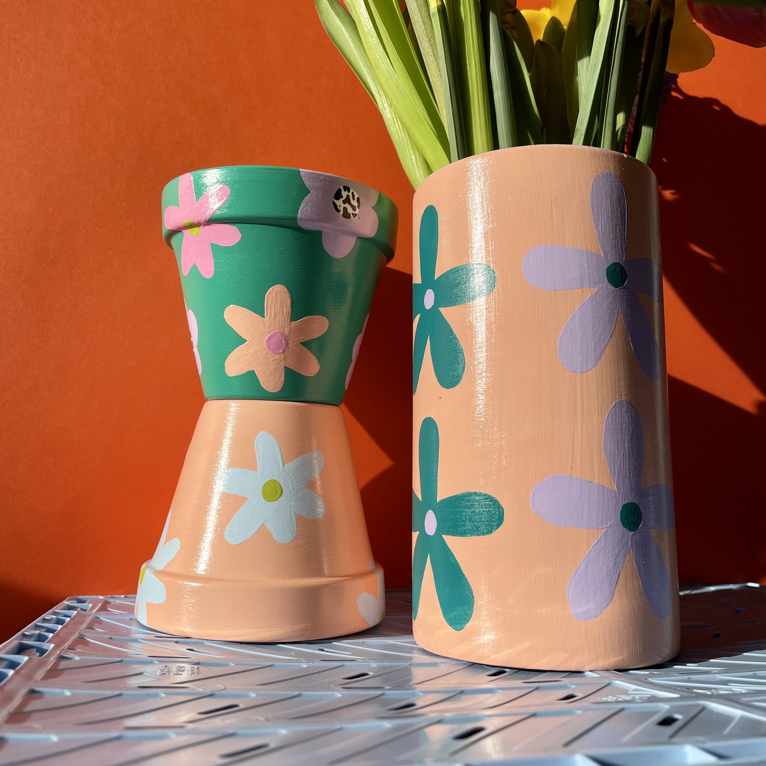 plant pots with flower painted on them