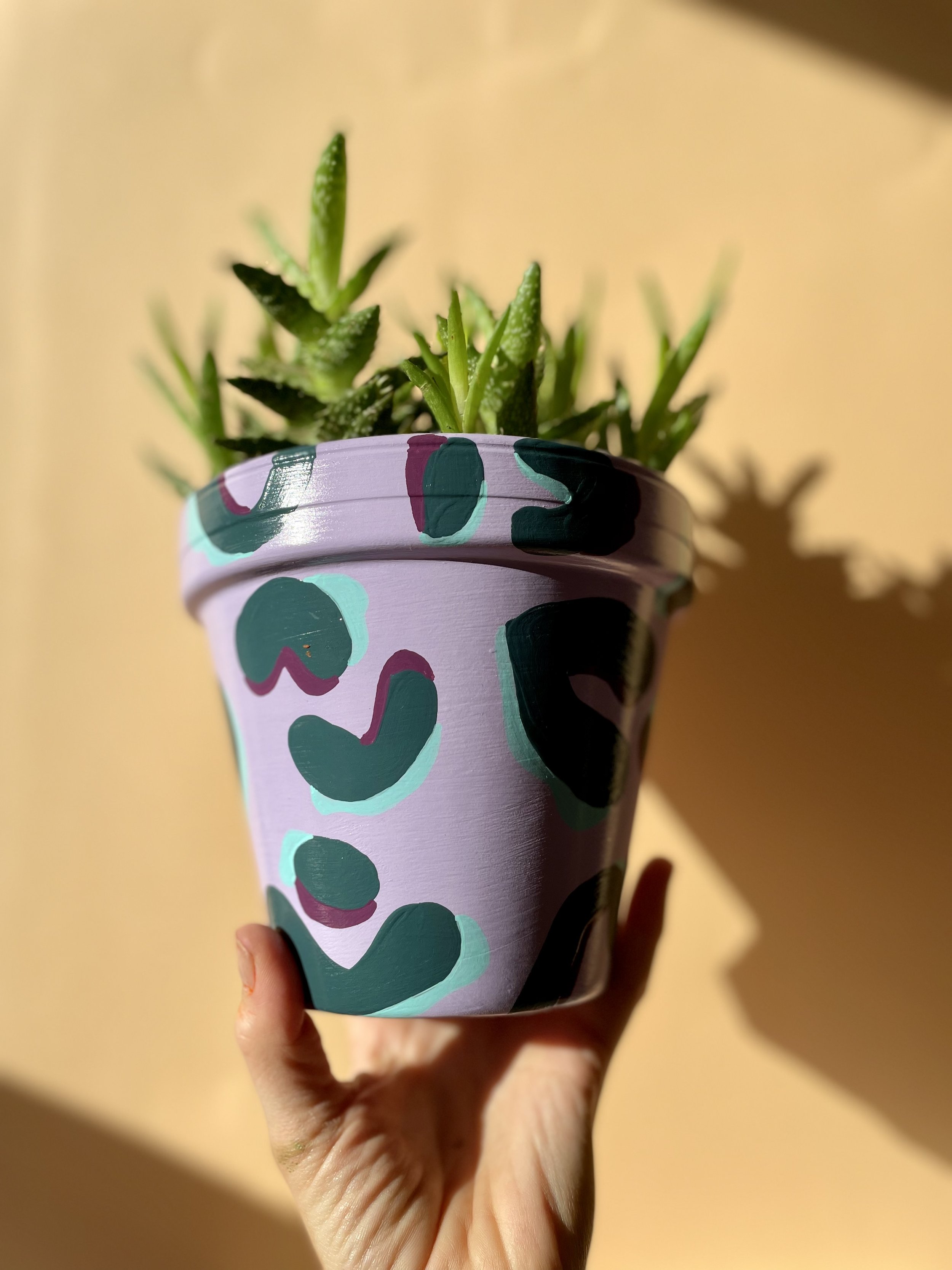 lilac and dark green plant pot