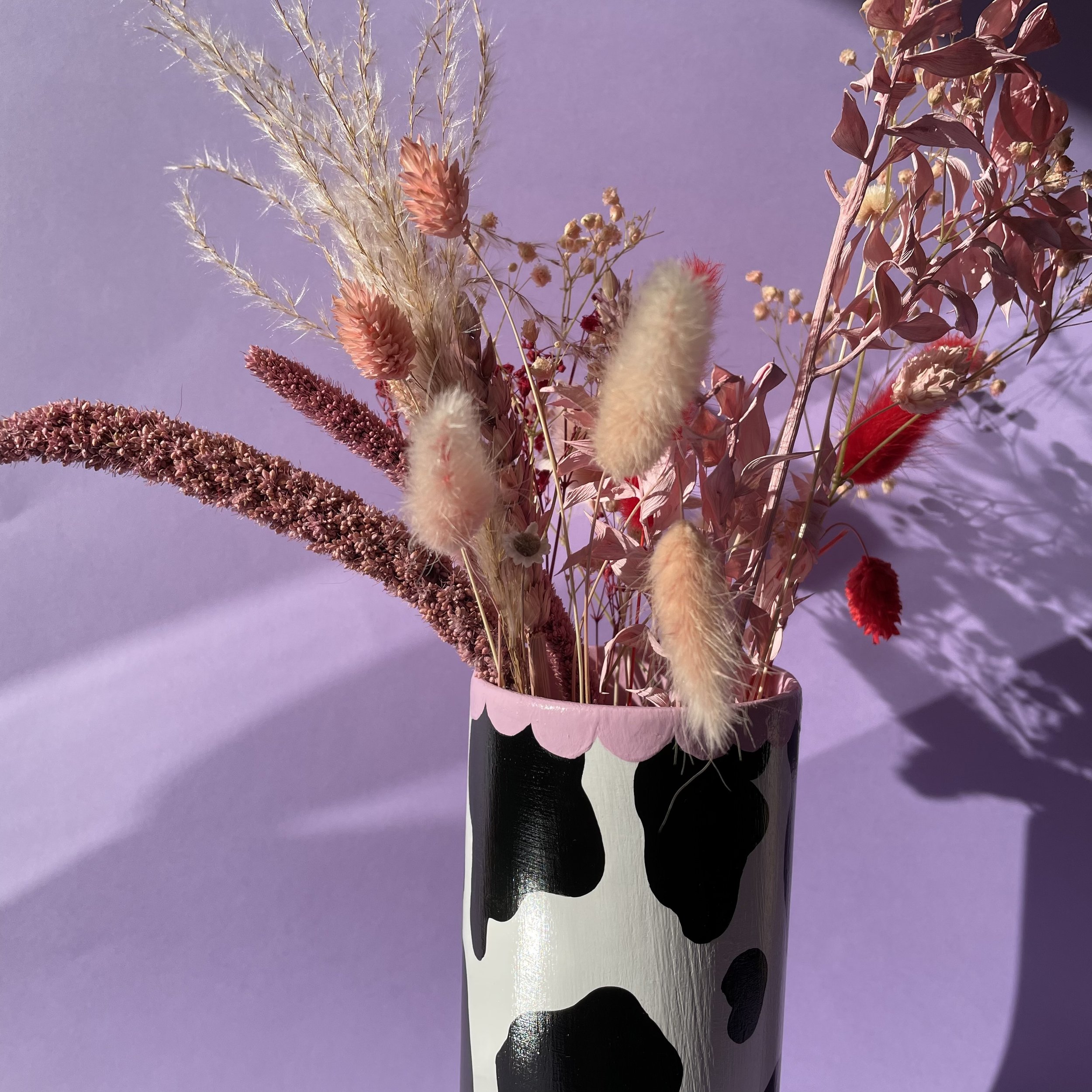 cow print vase with dried flowers