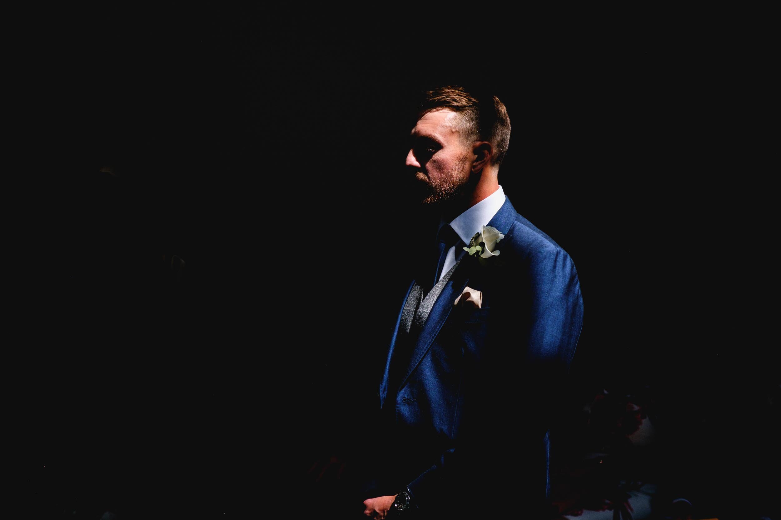 candid portrait of a wedding groom waiting for his bride at easton grange