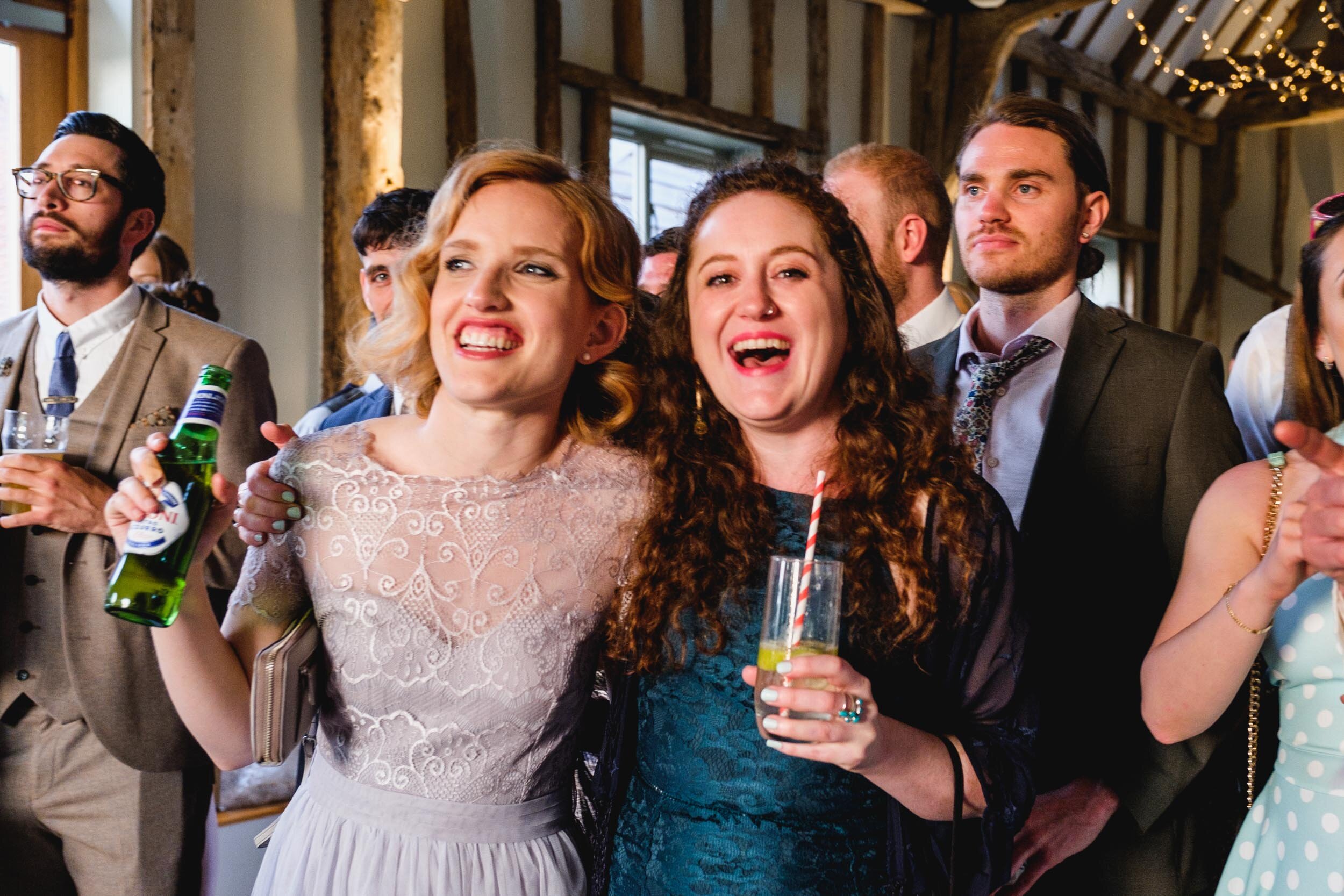 wedding guests smiling and cheering during wedding couples first dance