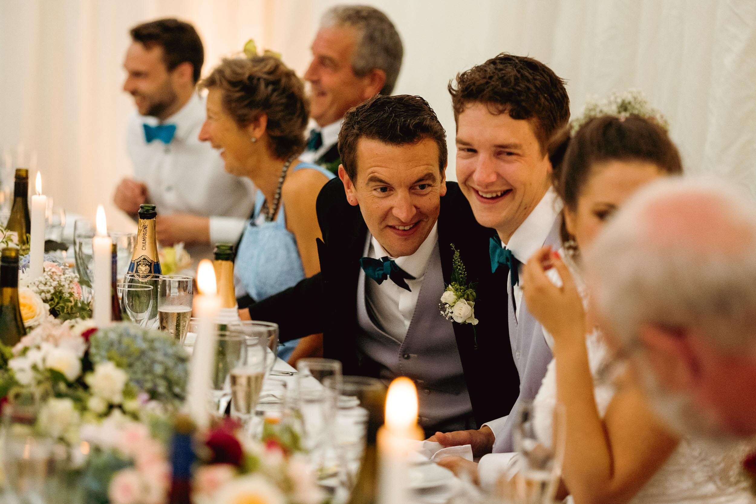 wedding guests sharing a joke during a wedding breakfast