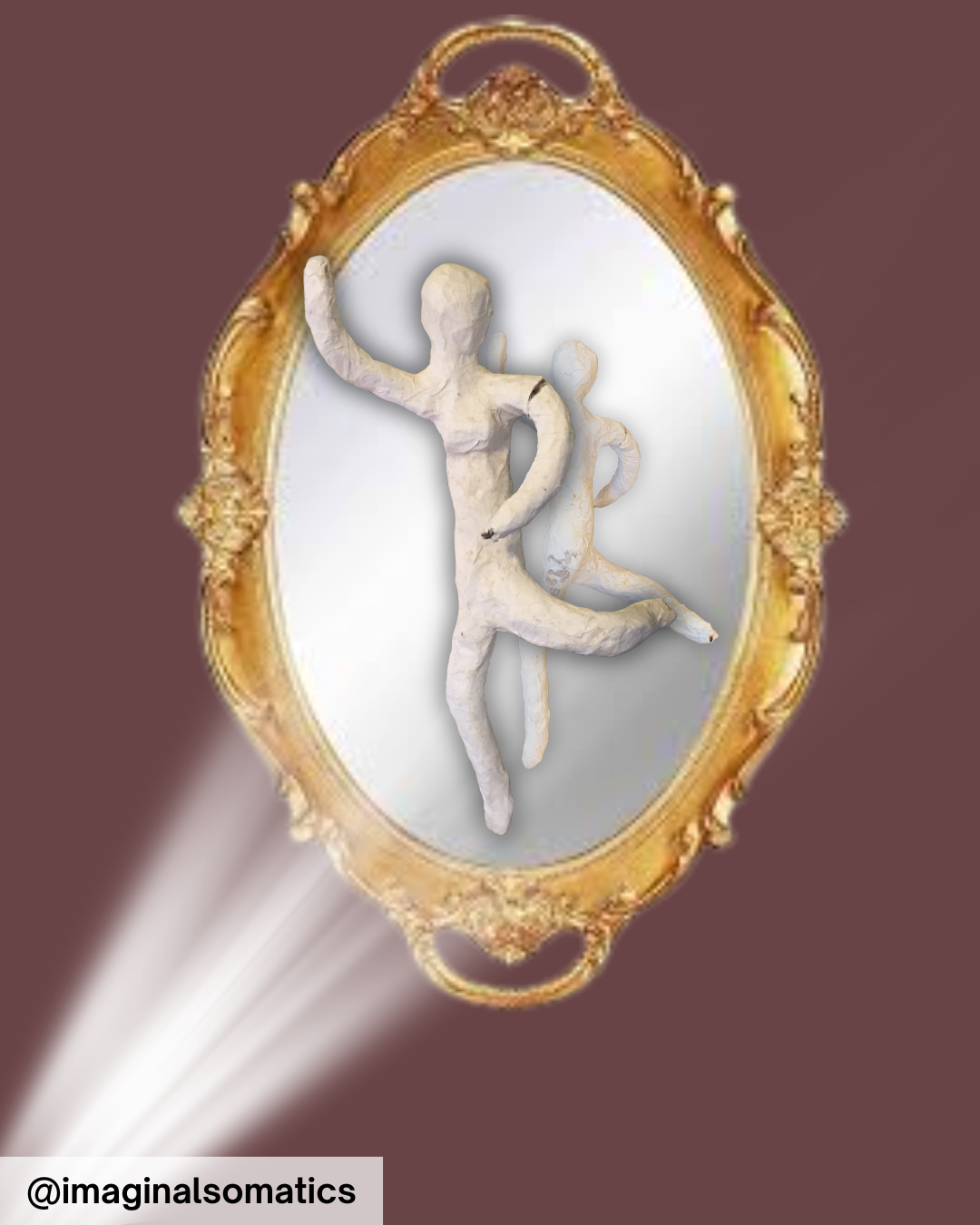 An ornate gold-framed mirror reflecting two abstract, humanoid sculptures with exaggerated curves and poses, set against a plain background.