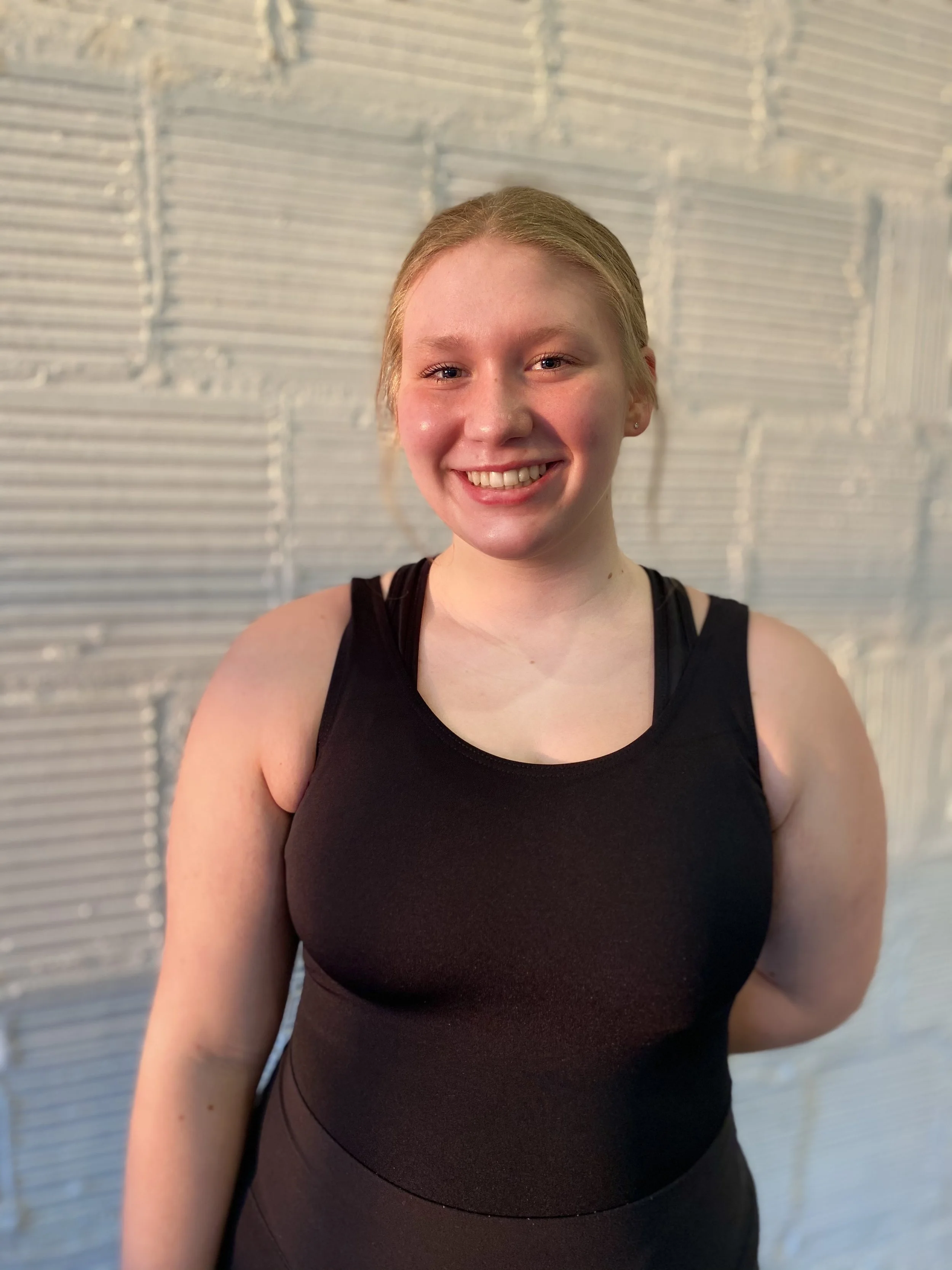 smile blonde shadow golden hour sunset black leotard white brick wall Dance dancer studio acting ballet jazz lyrical contemporary theater musical camp singing voice glee club Amber Keeley director Mpls classes twin cities workshops Spring Dance Theat