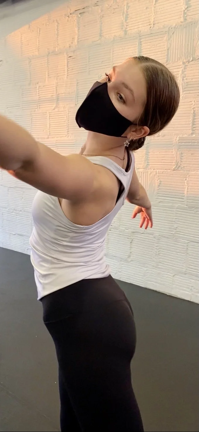 moving girl white shirt white brick wall Dance dancer acting ballet jazz lyrical contemporary theater musical camp singing voice glee club Amber Keeley director Mpls classes twin cities workshops Spring Dance Theatre Academy NE Minneapolis MN St St. 