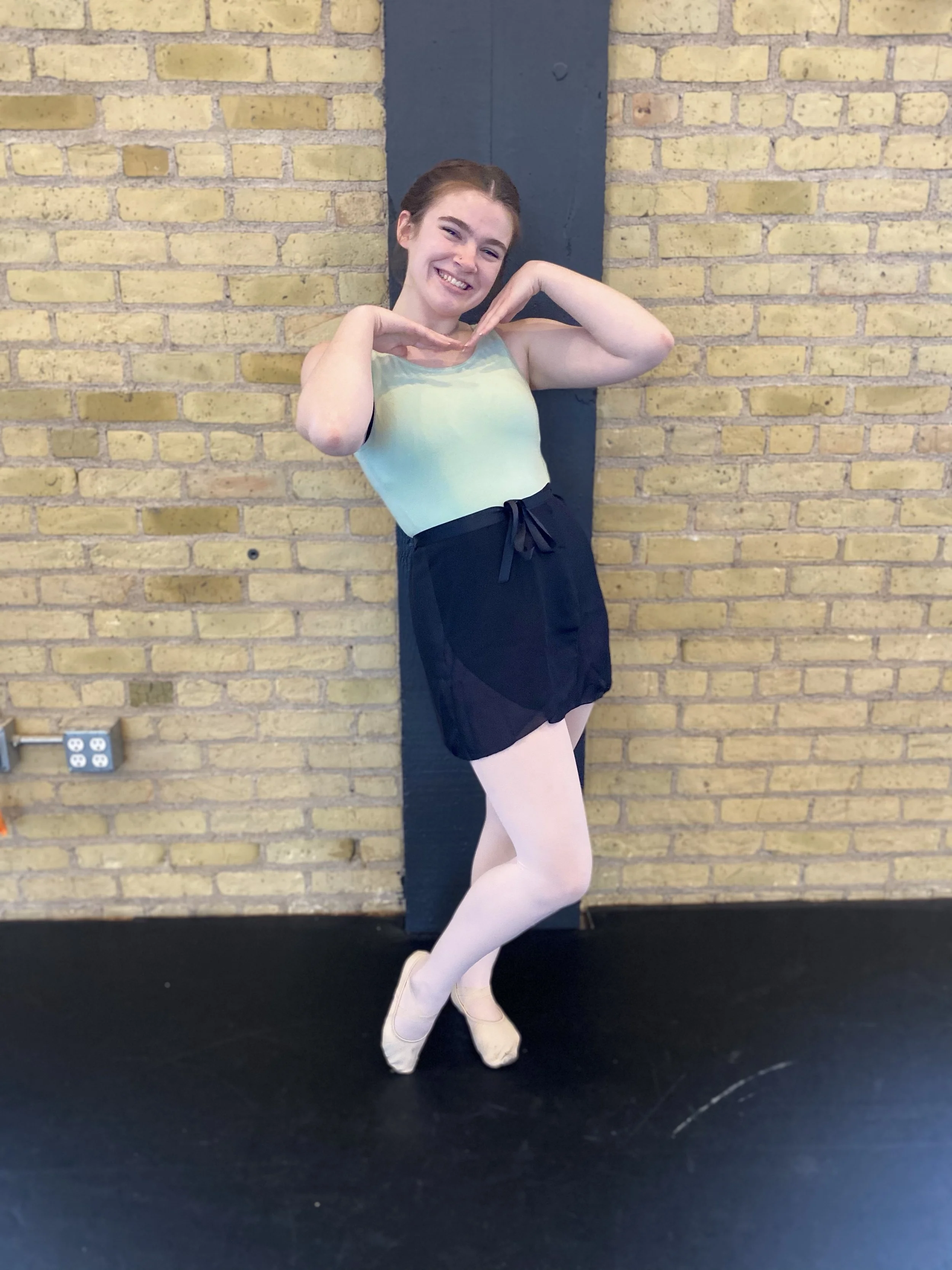 smile yellow brick black pole green leotard girl black skirt Dance dancer acting ballet jazz lyrical contemporary theater musical camp singing voice glee club Amber Keeley director Mpls classes twin cities workshops Spring Dance Theatre Academy NE Mi