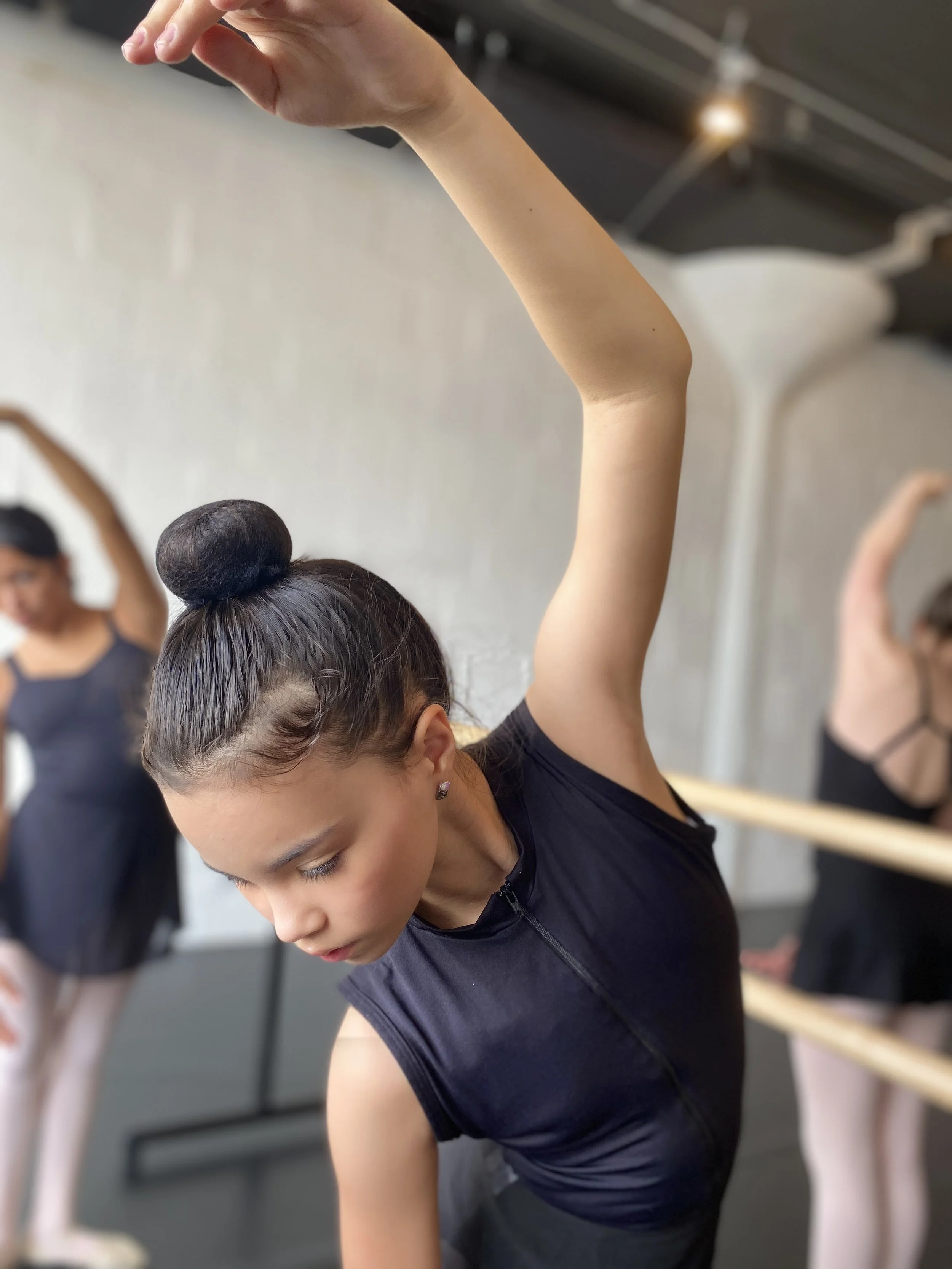 barre black leotard bun stretch away from barre Dance acting ballet jazz lyrical contemporary theater musical camp singing voice glee club Amber Keeley director Mpls classes twin cities workshops Spring Dance Theatre Academy NE Minneapolis MN St St. 