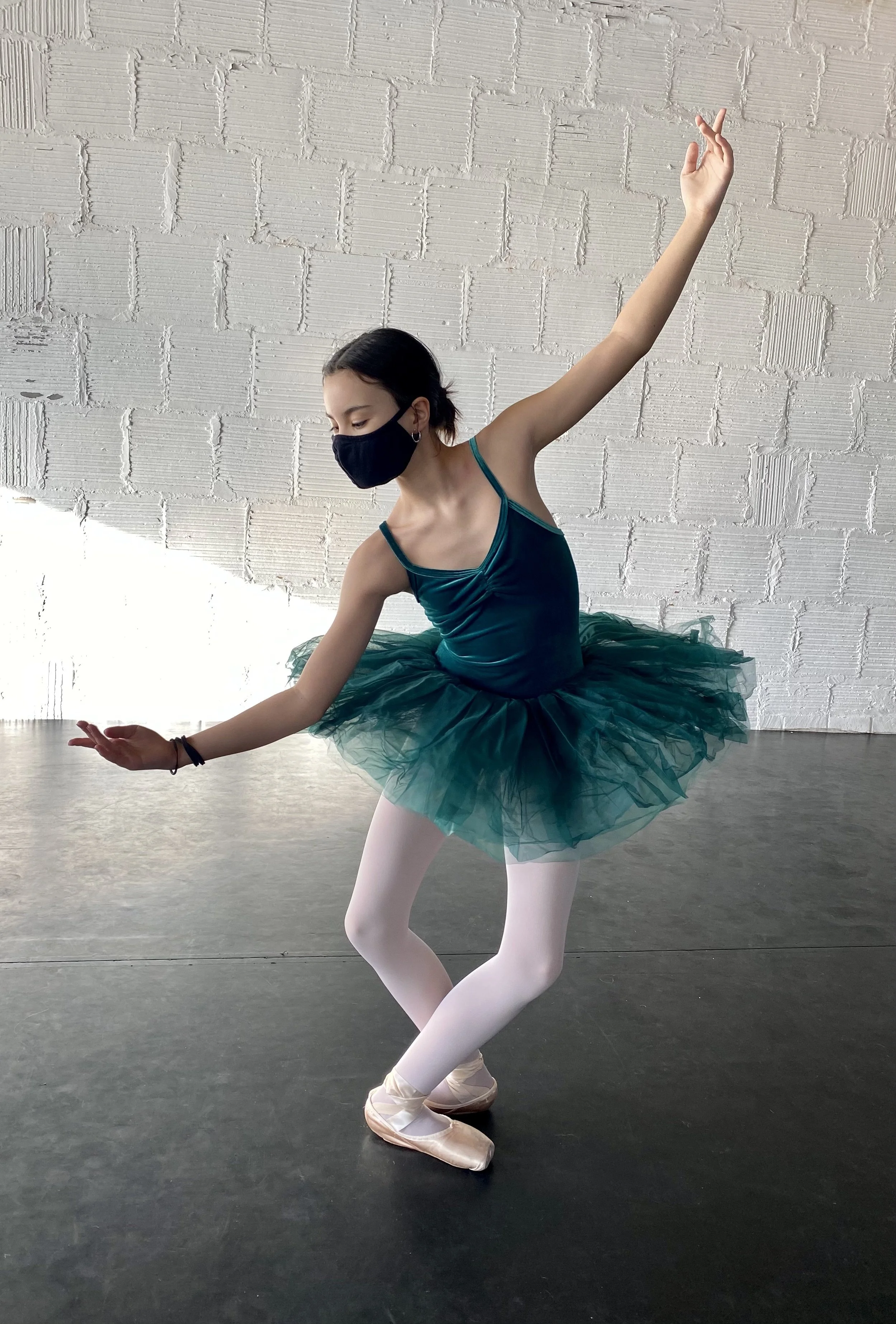 plié pointe shoes emerald tutu white brick wall Dance dancer studio acting ballet jazz lyrical contemporary theater musical camp singing voice glee club Amber Keeley director Mpls classes twin cities workshops Spring Dance Theatre Academy NE Minneapo