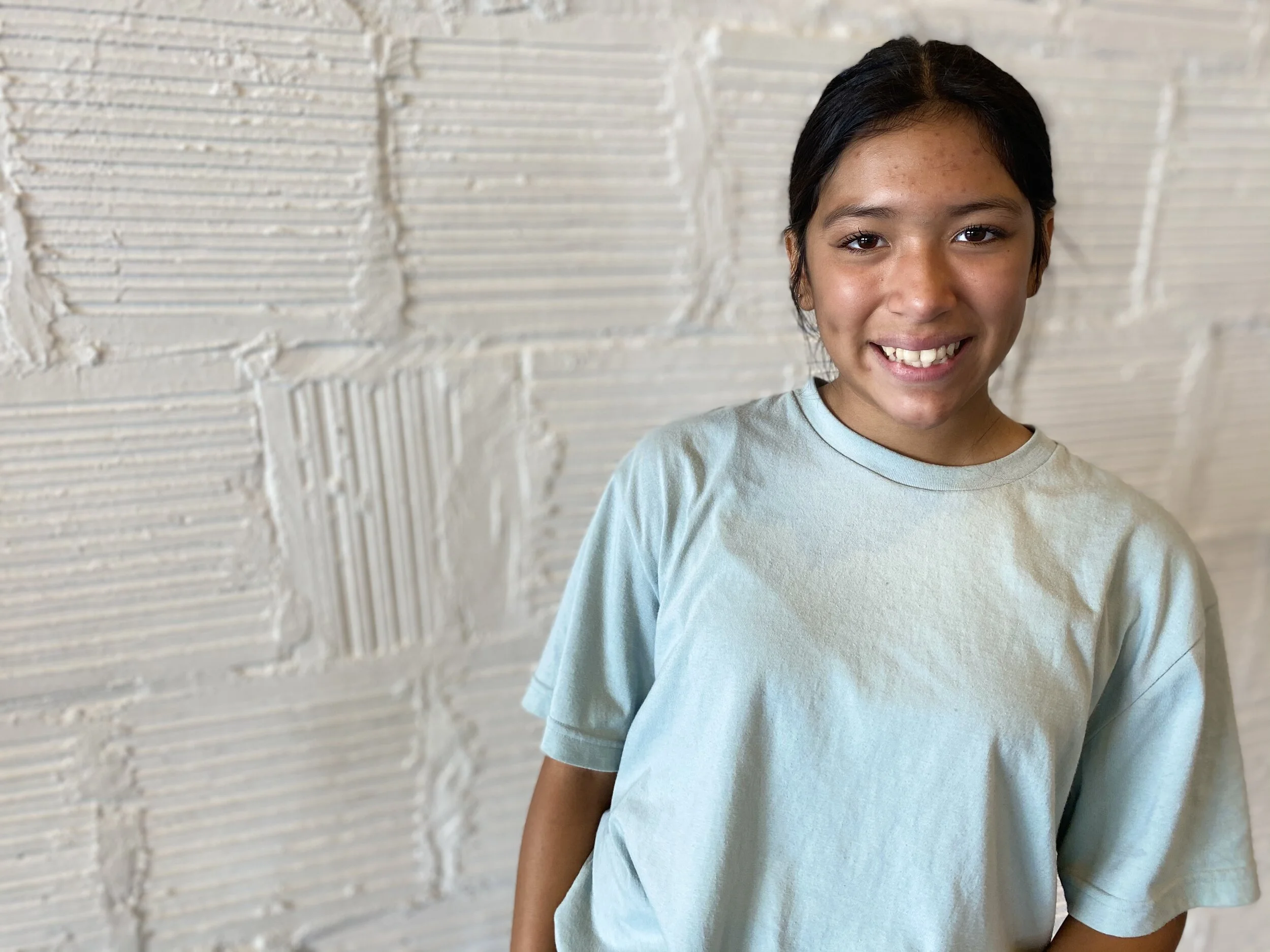 smile teal top white brick wall Dance acting ballet jazz lyrical contemporary theater musical camp singing voice glee club Amber Keeley director Mpls classes twin cities workshops Spring Dance Theatre Academy NE Minneapolis MN St St. Saint Paul Minne