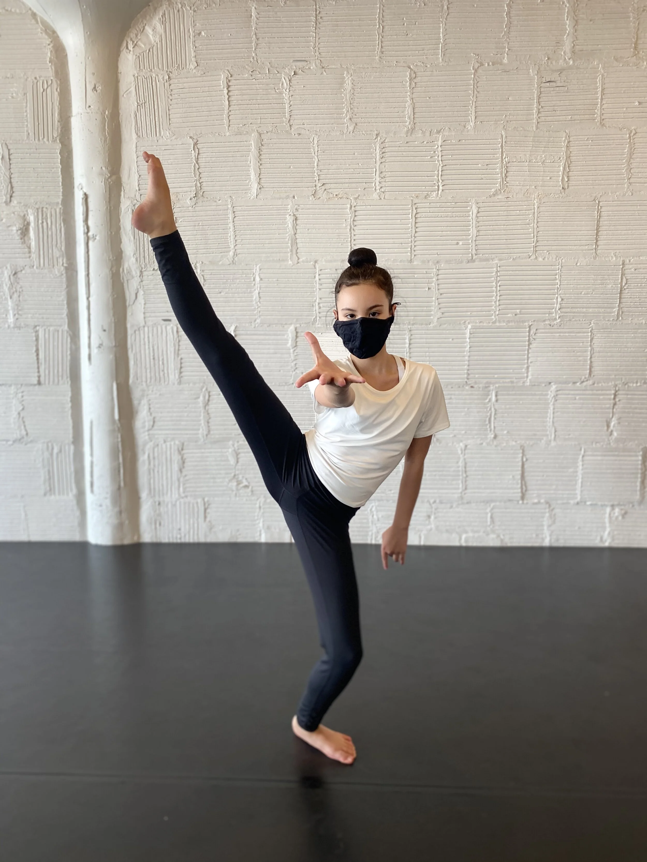 reaching legs white top white brick wall Dance acting ballet jazz lyrical contemporary theater musical camp singing voice glee club Amber Keeley director Mpls classes twin cities workshops Spring Dance Theatre Academy NE Minneapolis MN St St. Saint P