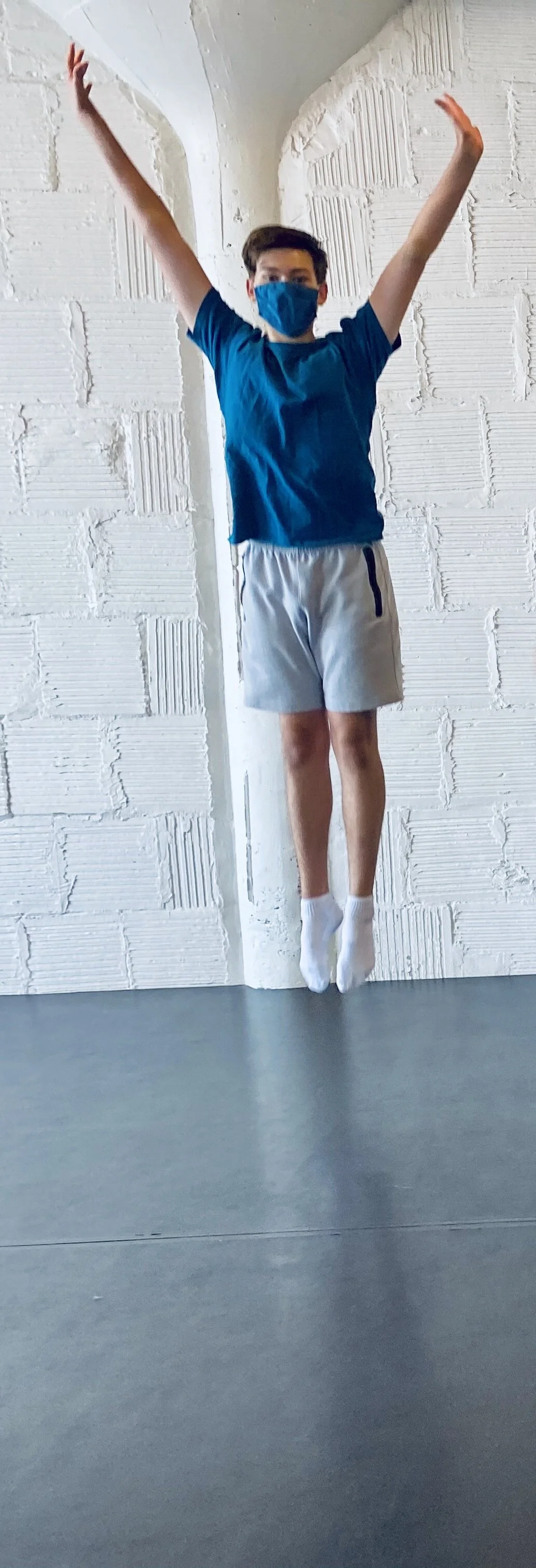 boy blue shirt jumping white brick wall Dance acting ballet jazz lyrical contemporary theater musical camp singing voice glee club Amber Keeley director Mpls classes twin cities workshops Spring Dance Theatre Academy NE Minneapolis MN St St. Saint Pa