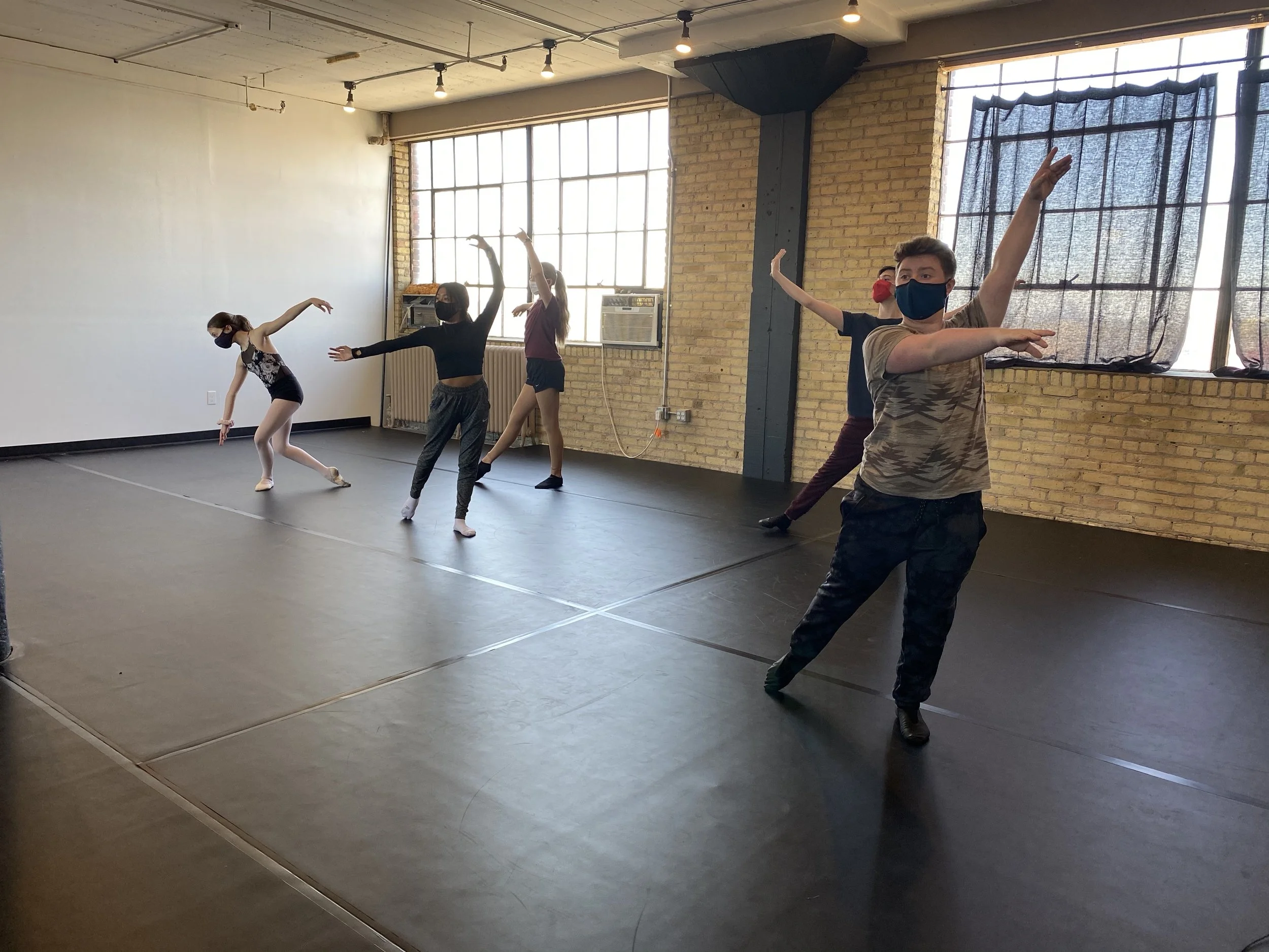 pose two boys 3 girls yellow brick wall black floor windows Dance dancer acting ballet jazz lyrical contemporary theater musical camp singing voice glee club Amber Keeley director Mpls classes twin cities workshops Spring Dance Theatre Academy NE Min