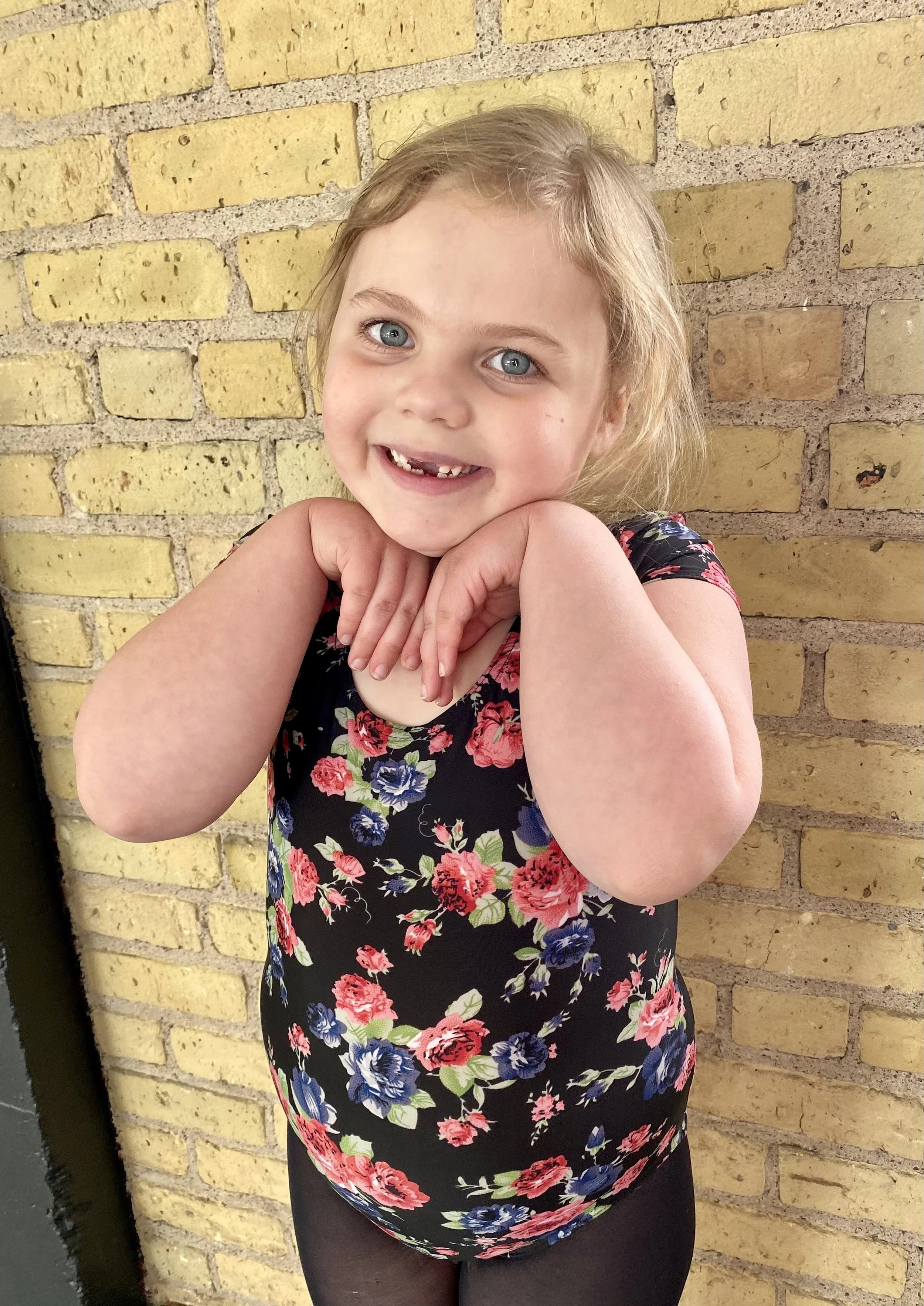 yellow brick wall black tights flower leotard smile cute Dance dancer studio acting ballet jazz lyrical contemporary theater musical camp singing voice glee club Amber Keeley director Mpls classes twin cities workshops Spring Dance Theatre Academy NE