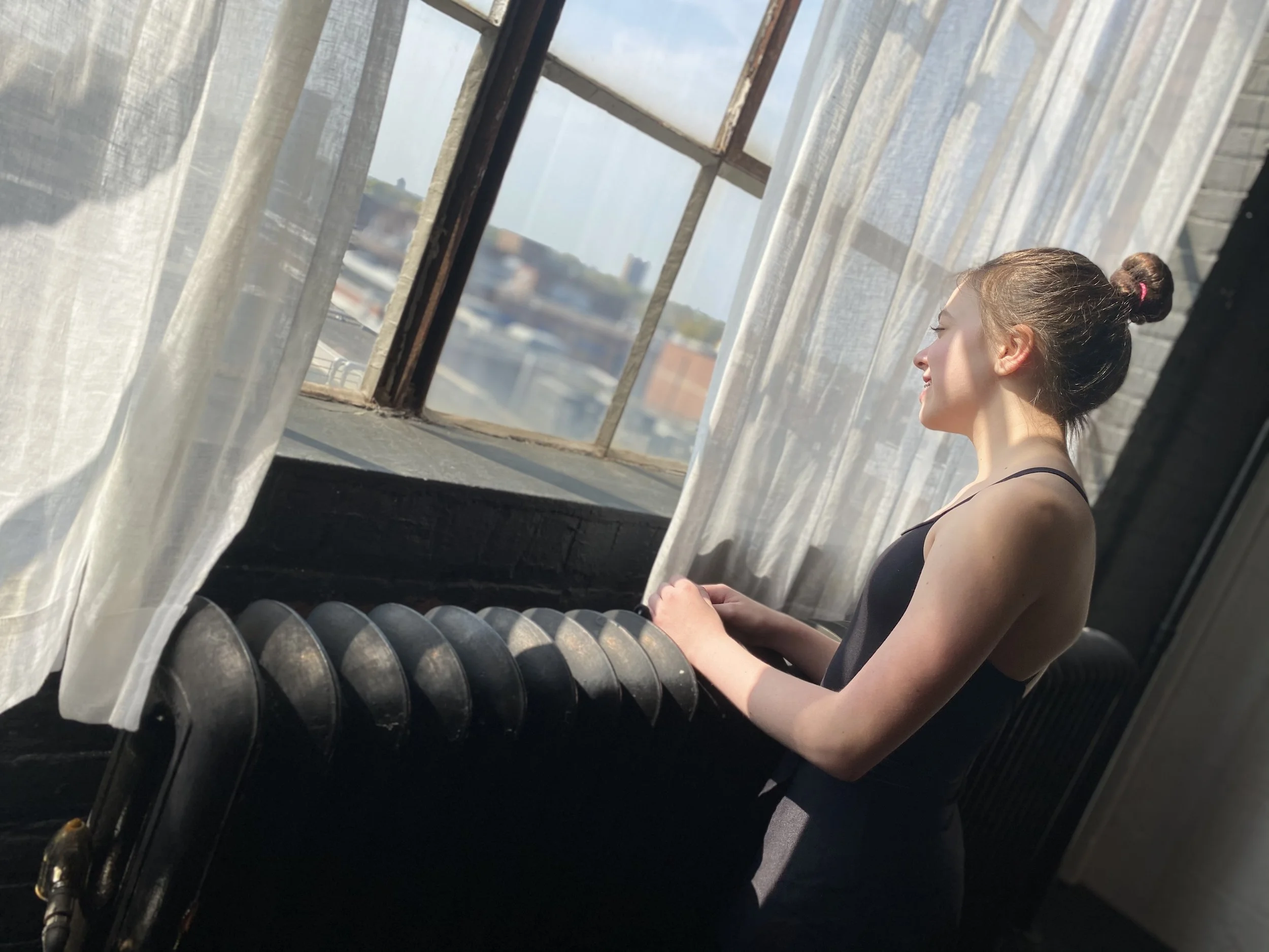  window white curtains girl hair in bun shadows Dance acting ballet jazz lyrical contemporary theater musical camp singing voice glee club Amber Keeley director Mpls classes twin cities workshops Spring Dance Theatre Academy NE Minneapolis MN St St. 