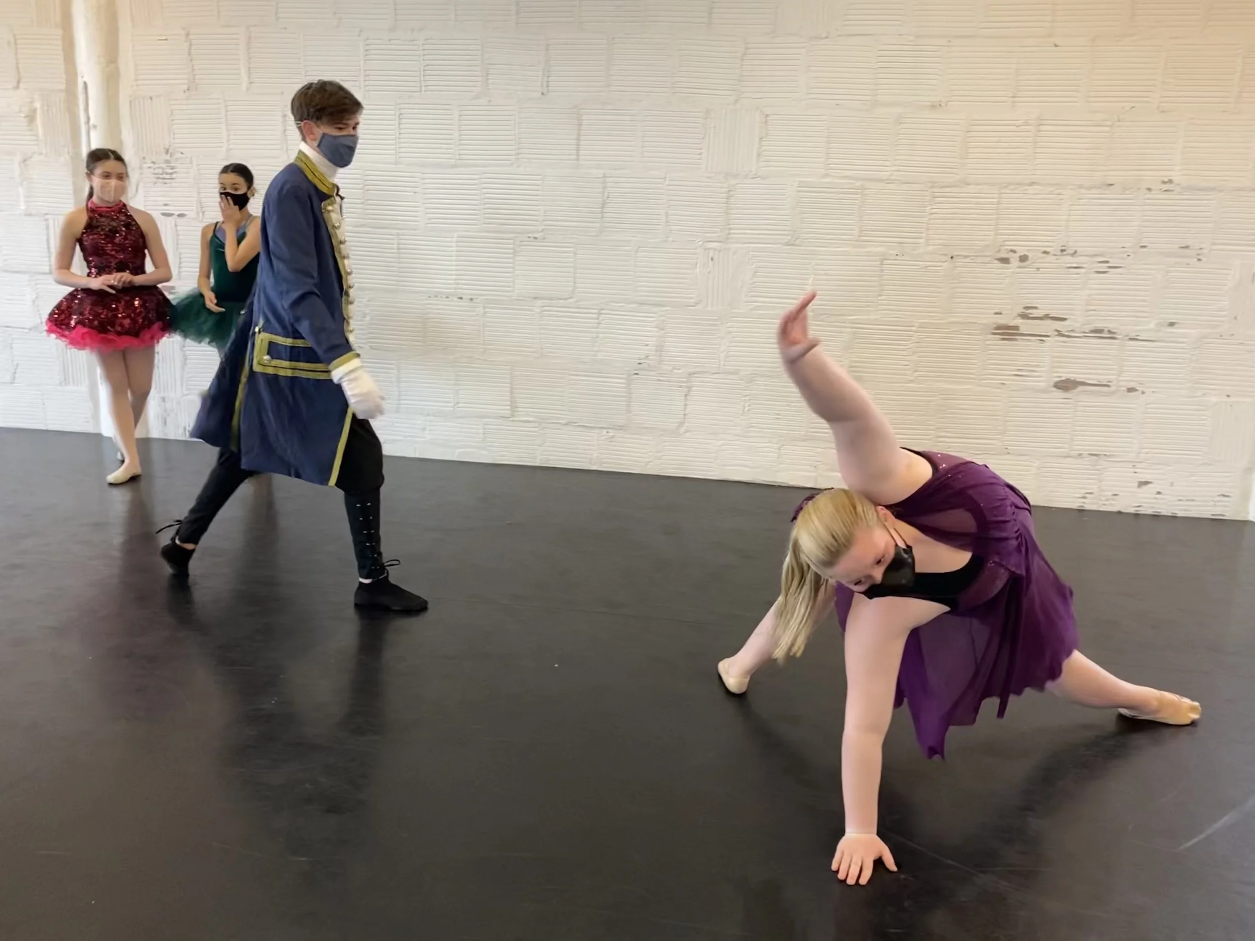 Prince Charming princess plum purple dress arch arm up white brick wall two girls in background pink tutu emerald green tutu Dance dancer studio acting ballet jazz lyrical contemporary theater musical camp singing voice glee club Amber Keeley directo