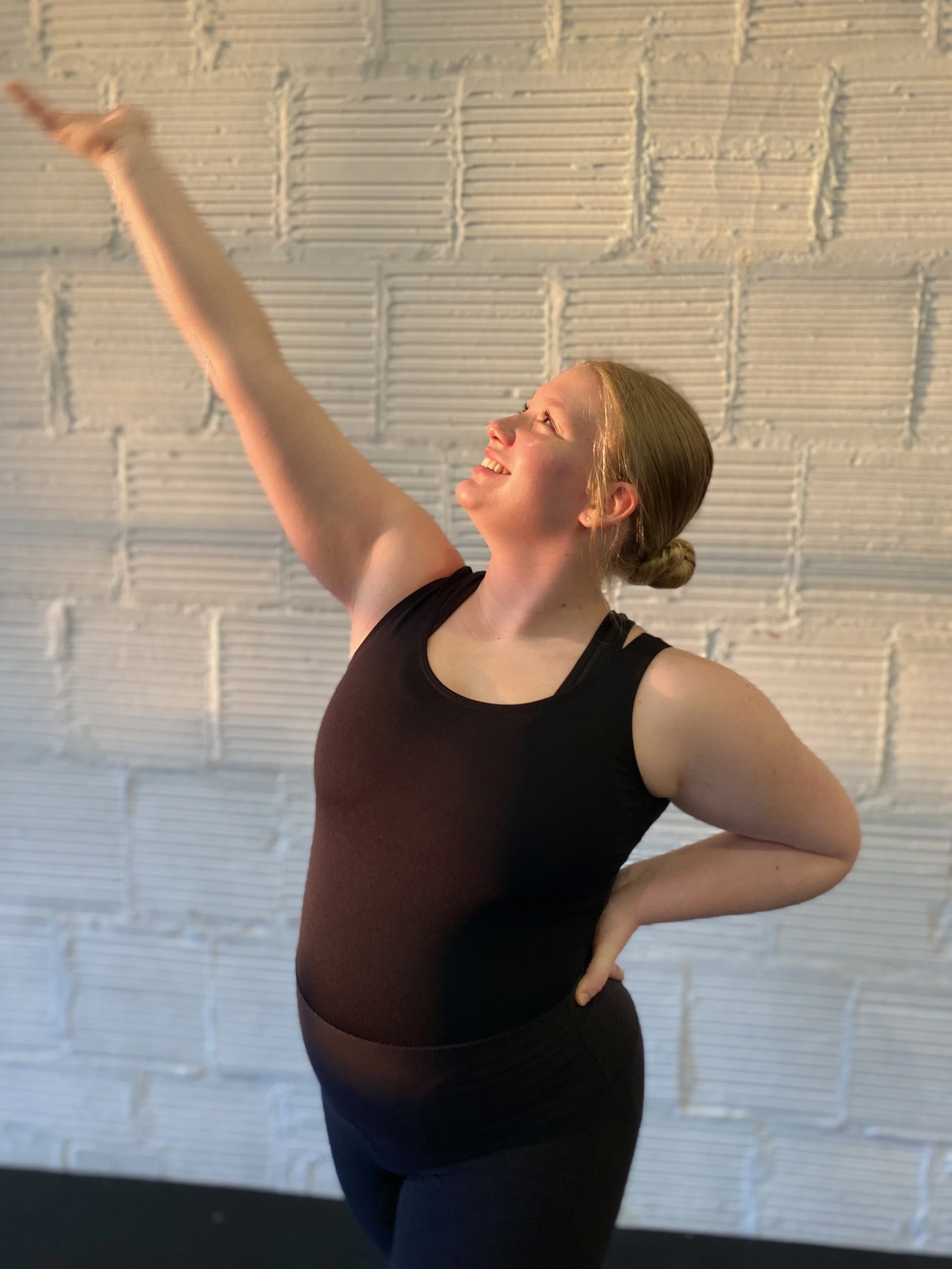 black leotard arm up hair in bun golden hour Dance dancer studio acting ballet jazz lyrical contemporary theater musical camp singing voice glee club Amber Keeley director Mpls classes twin cities workshops Spring Dance Theatre Academy NE Minneapolis