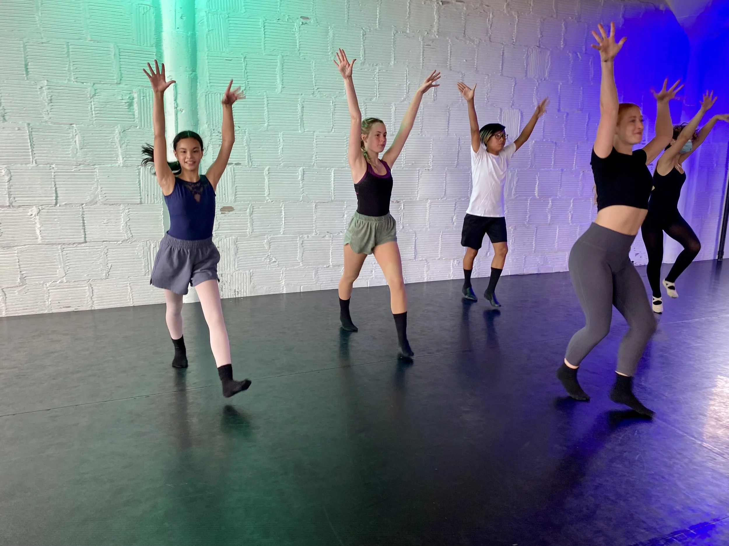 jazz hands learning teaching teacher Lauren Kubitschek white brick wall blue green lights black floor Dance dancer studio acting ballet jazz lyrical contemporary theater musical camp singing voice glee club Amber Keeley director Mpls classes twin cit