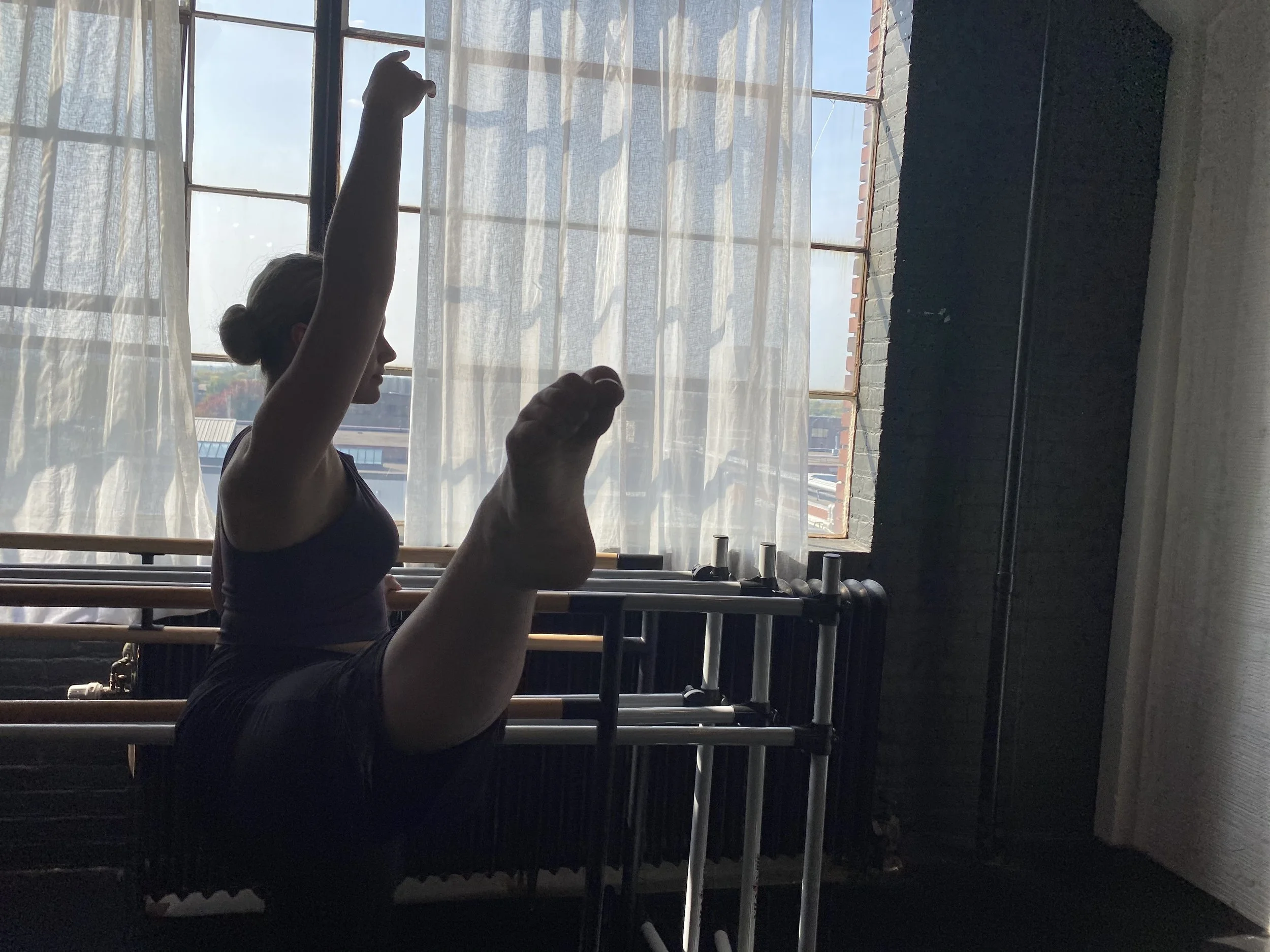 girl hair in bun arms in fifth window shadow Dance acting ballet jazz lyrical contemporary theater musical camp singing voice glee club Amber Keeley director Mpls classes twin cities workshops Spring Dance Theatre Academy NE Minneapolis MN St St. Sai