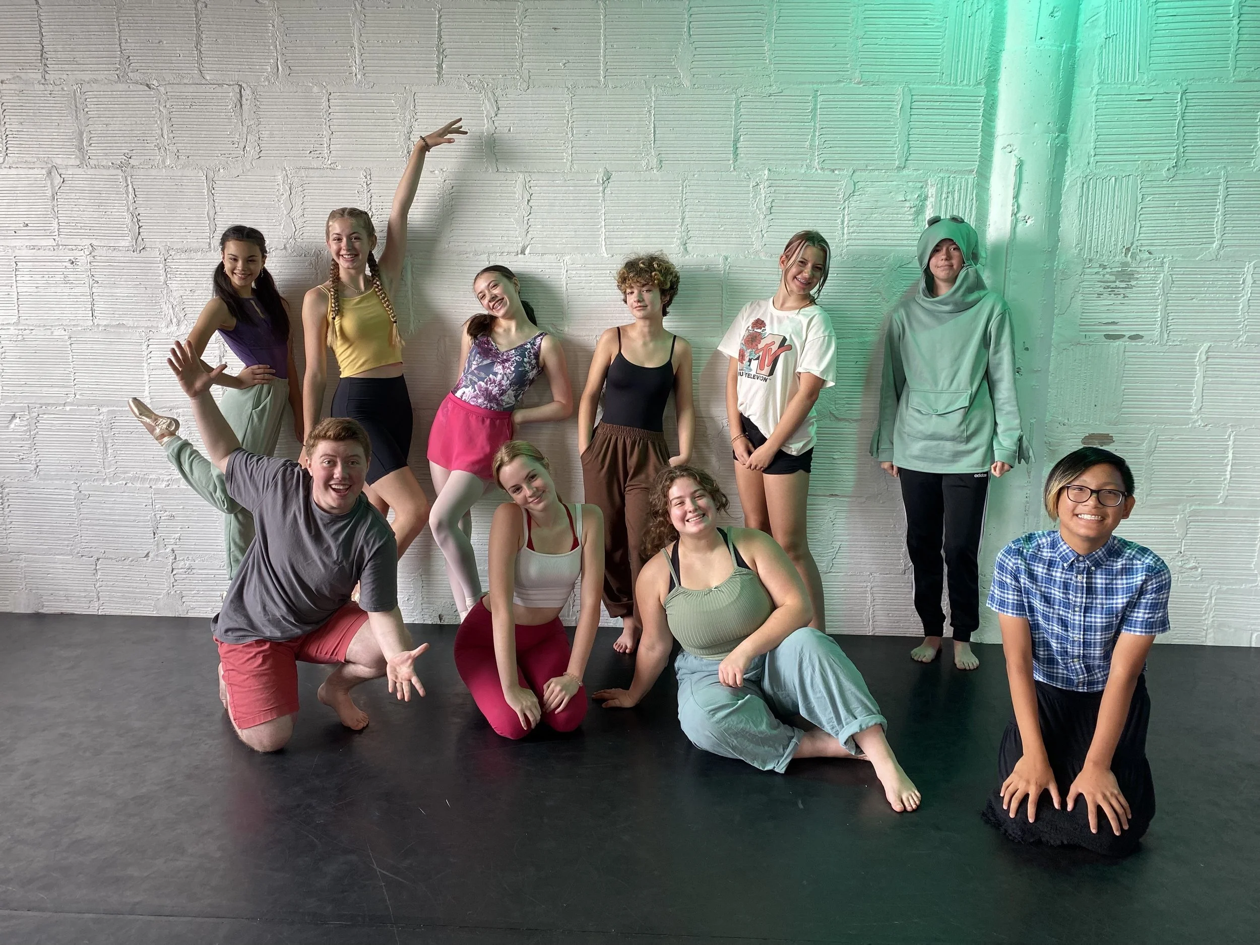 pink skirt smiles friends pose flower leotard tights green blue purple yellow black black floor white brick wall  Dance dancer studio acting ballet jazz lyrical contemporary theater musical camp singing voice glee club Amber Keeley director Mpls clas