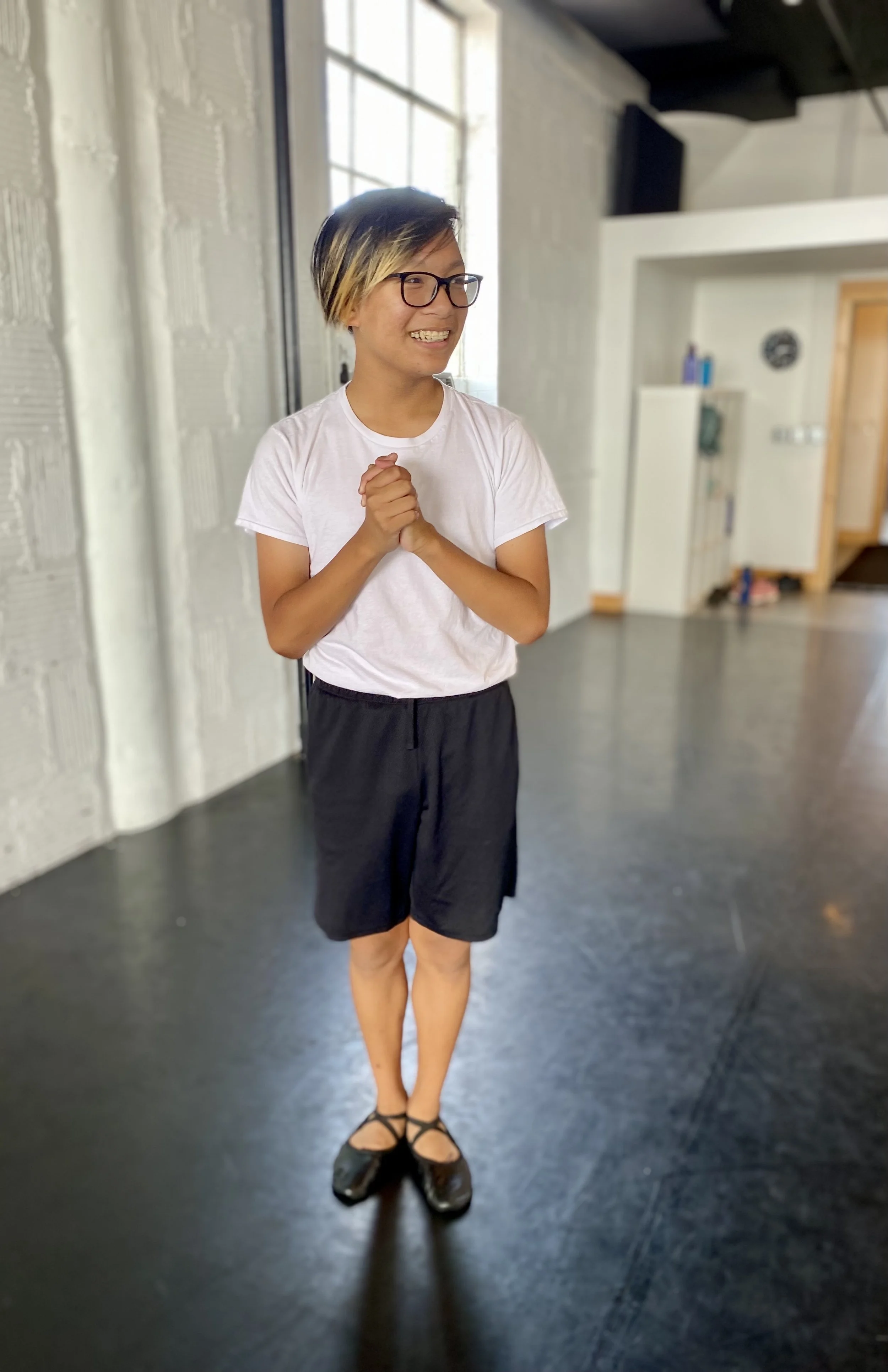 black floor white brick wall white shirt black shorts window  Dance dancer studio acting ballet jazz lyrical contemporary theater musical camp singing voice glee club Amber Keeley director Mpls classes twin cities workshops Spring Dance Theatre Acade