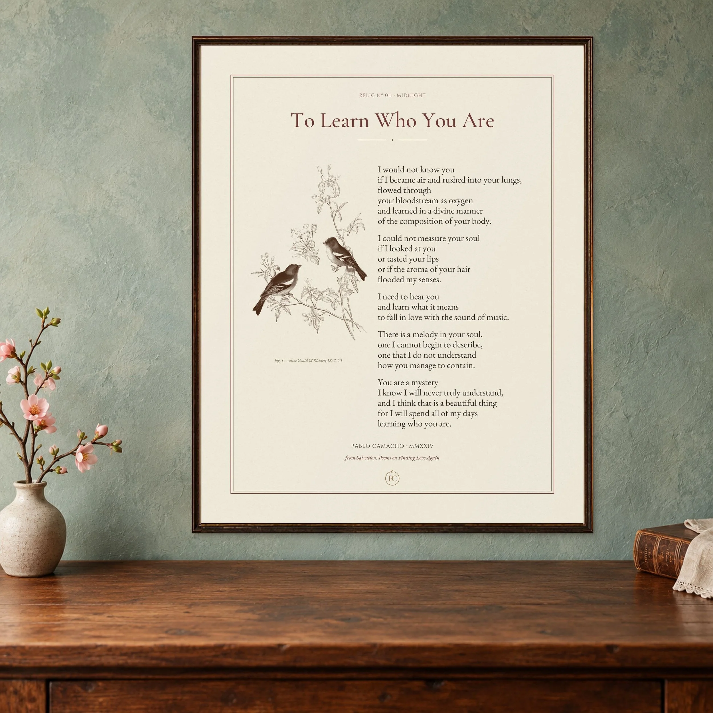 To Learn Who You Are poetry print with a pair of chaffinches, framed on a blue-green wall beside blossoms and an antique book