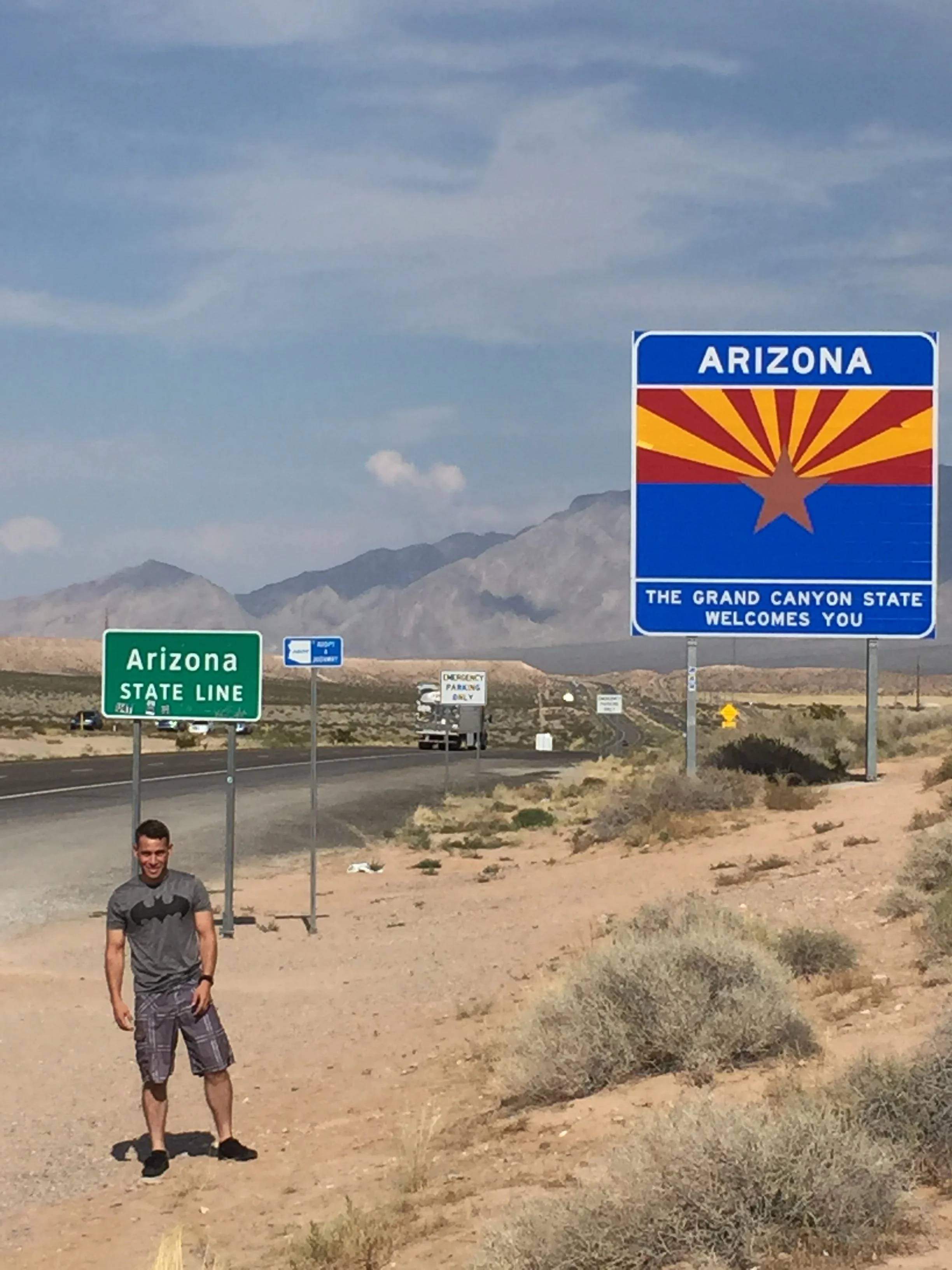 Pablo Camacho standing next to the highway by the Arizona state line