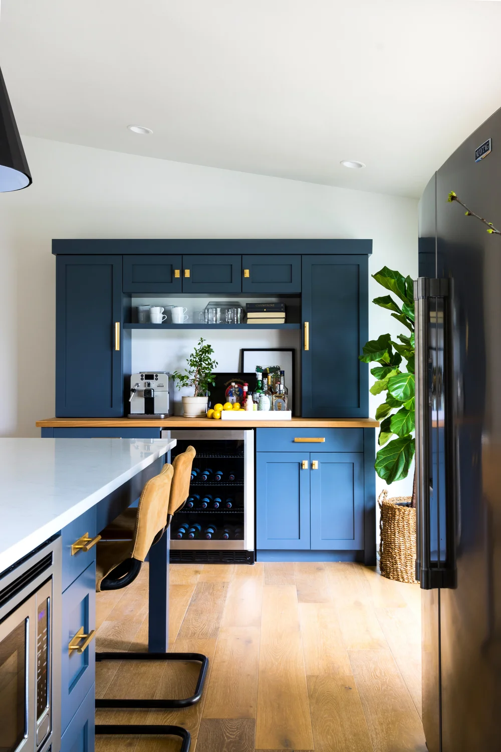 Blue cabinetry, warm wood and collected details in a Kirby Kelly interior