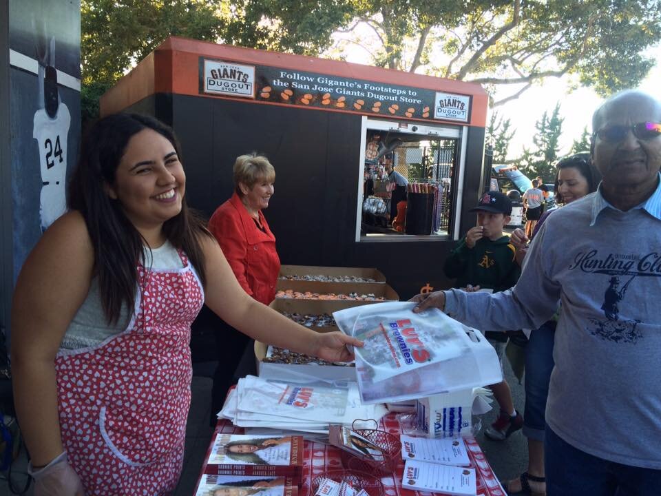 Handing out heart-shaped brownies Luv's Brownies 20 year anniversary at San Jose Giants Excite Ballpark (Copy)