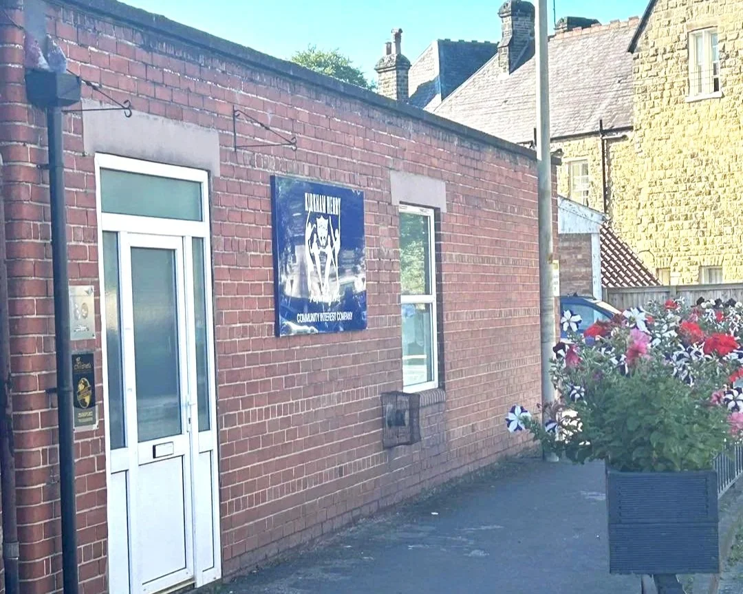 The front of the red brick building of the Kirkham Henry Performing Arts School