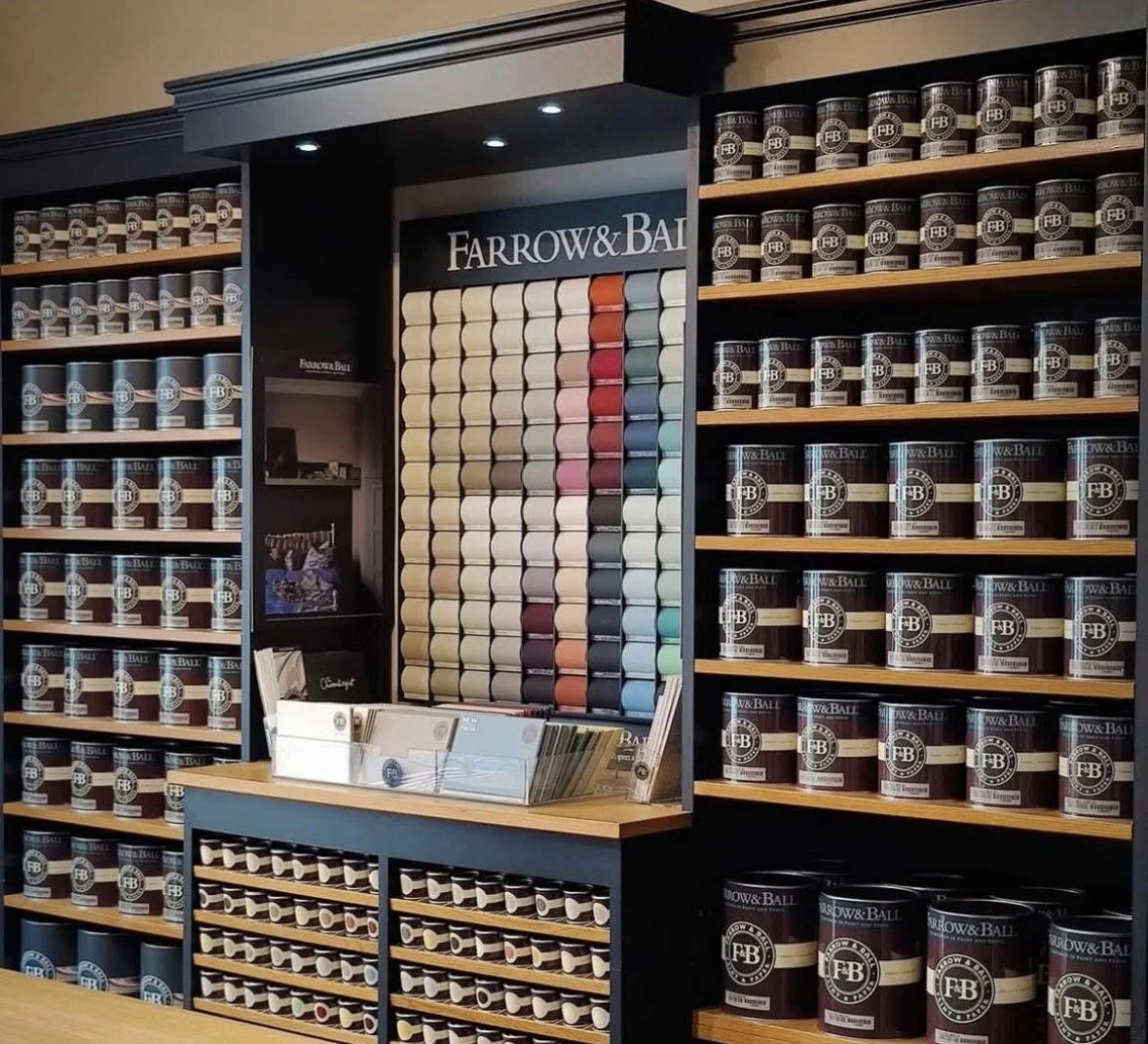 Wall of the shop displaying tins of paint