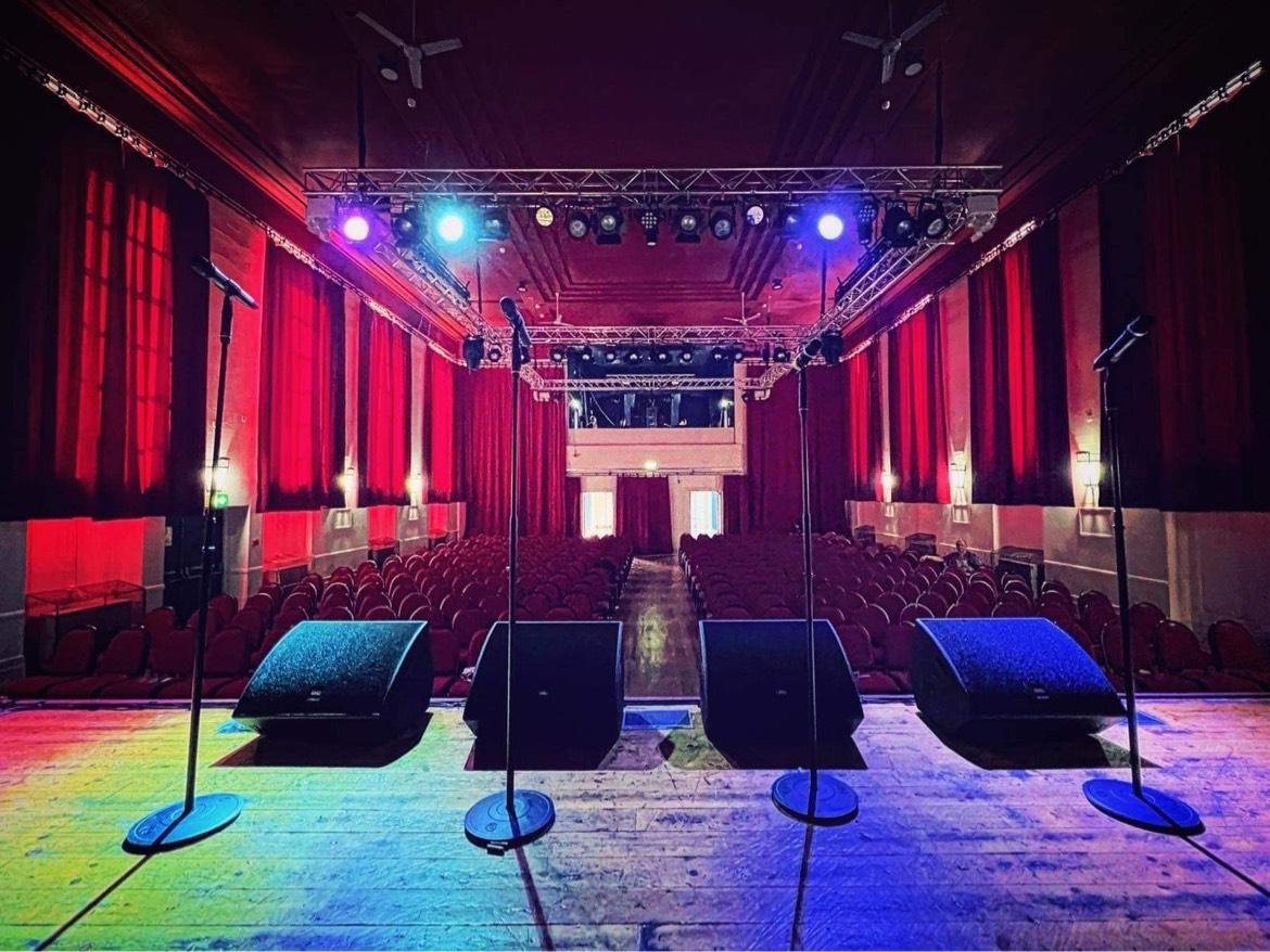 The view f rom the stage at The Milton Rooms looking towards the entrance over rows of chairs
