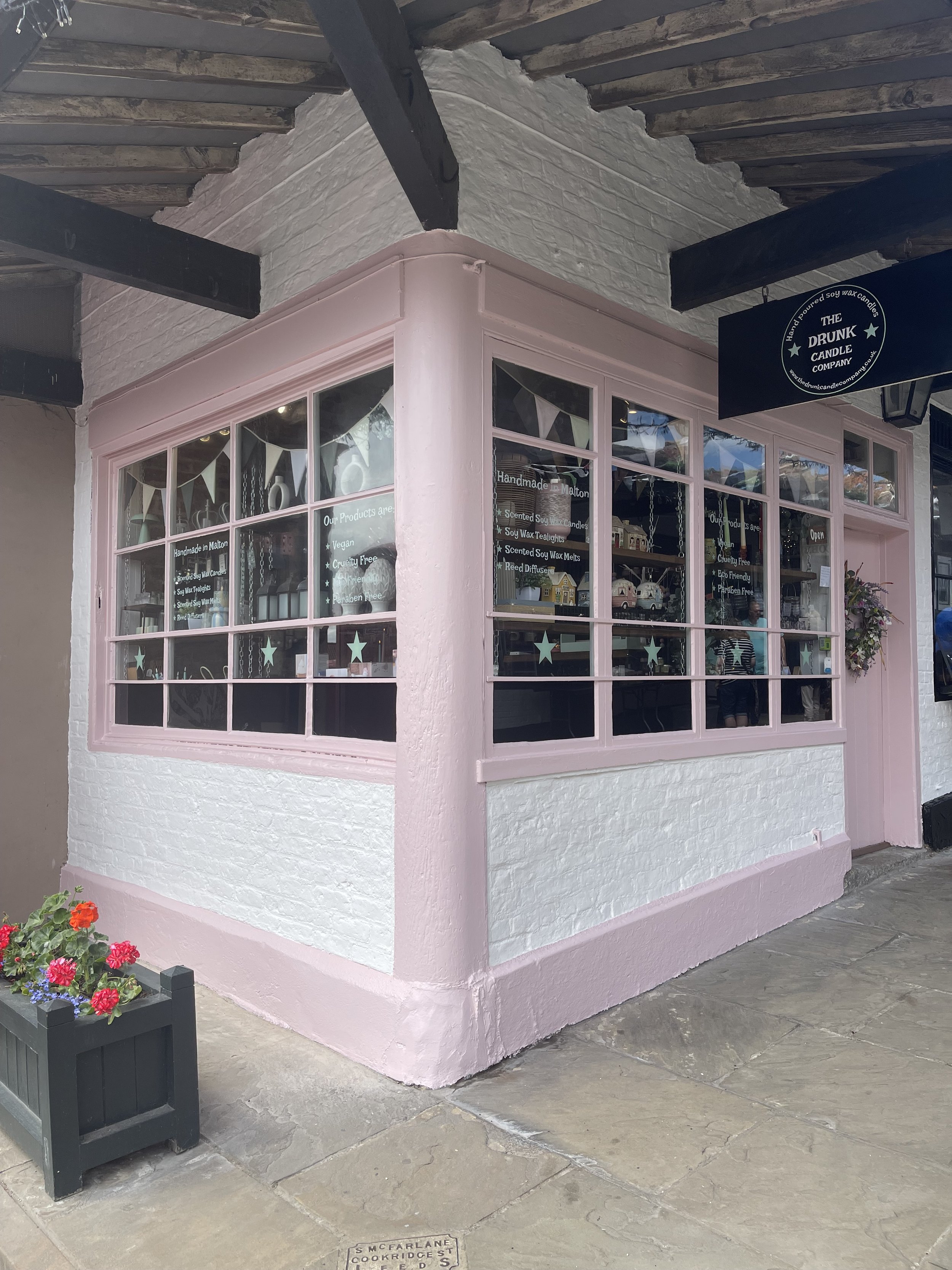 The pink and white frontage of The Drunk Candle