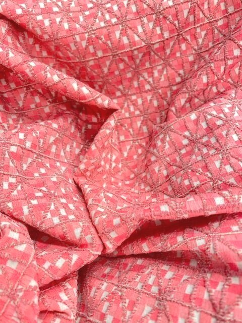 Bi stretch coral and vanilla jacquard fabric coupon with diamond pattern - draped