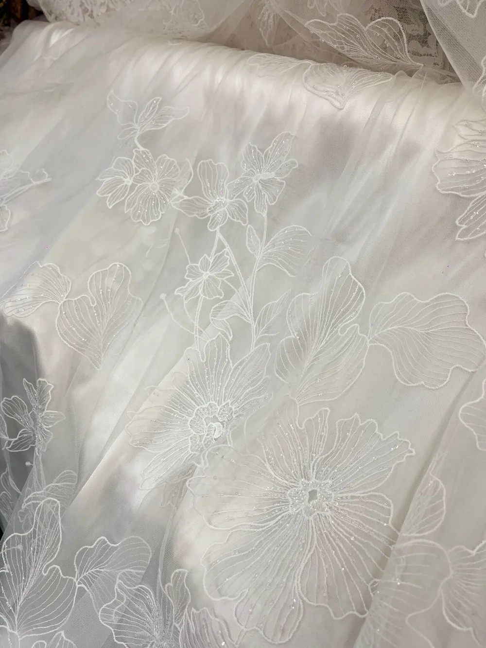 Off-white embroidered and beaded tulle with large floral motifs