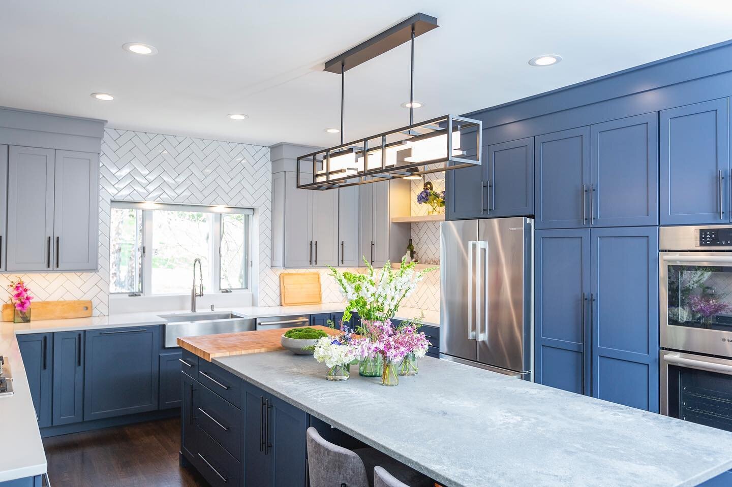We love an active kitchen! Our clients are always prepping &amp; cooking. 👩&zwj;🍳🧑&zwj;🍳We integrated ease and convenience into the island design with the custom maple butcher block. The natural color pops against the concrete quartz &amp; blue c