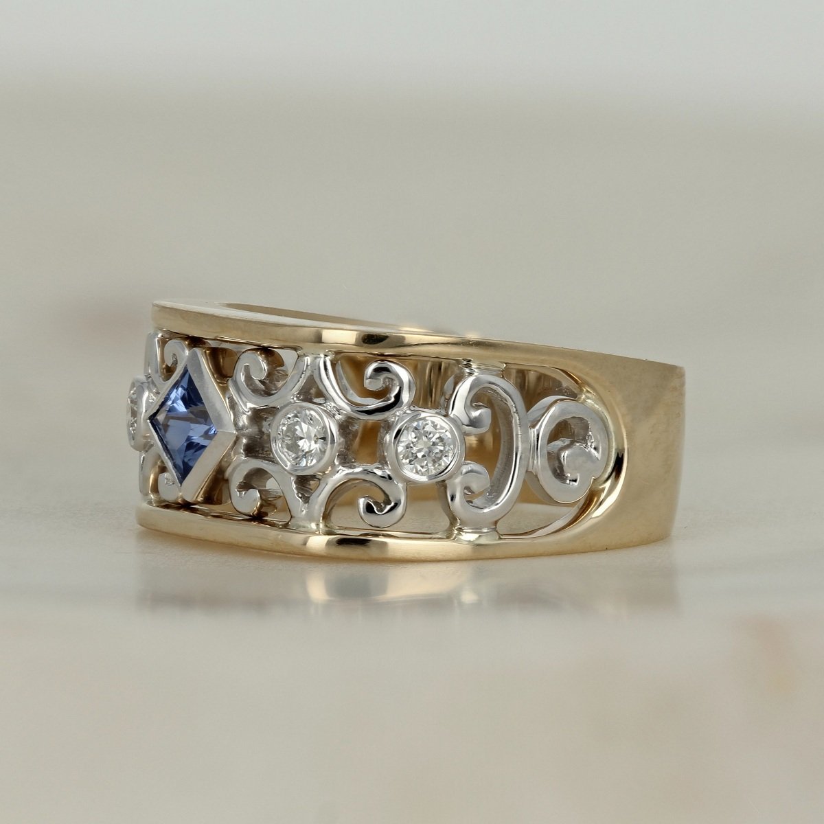 14k two tone yellow and white gold princess cut blue sapphire accent diamond scroll ring