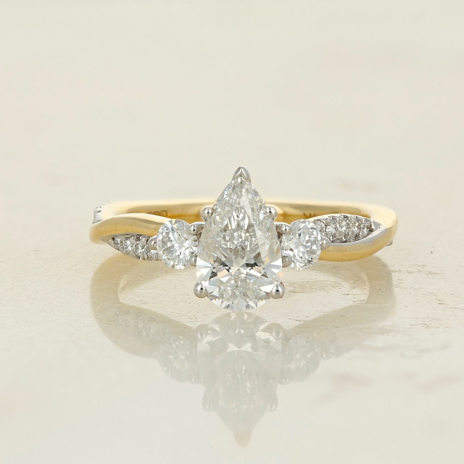 14k two tone yellow and white gold lab diamond pear shaped twisted infinity band engagement ring