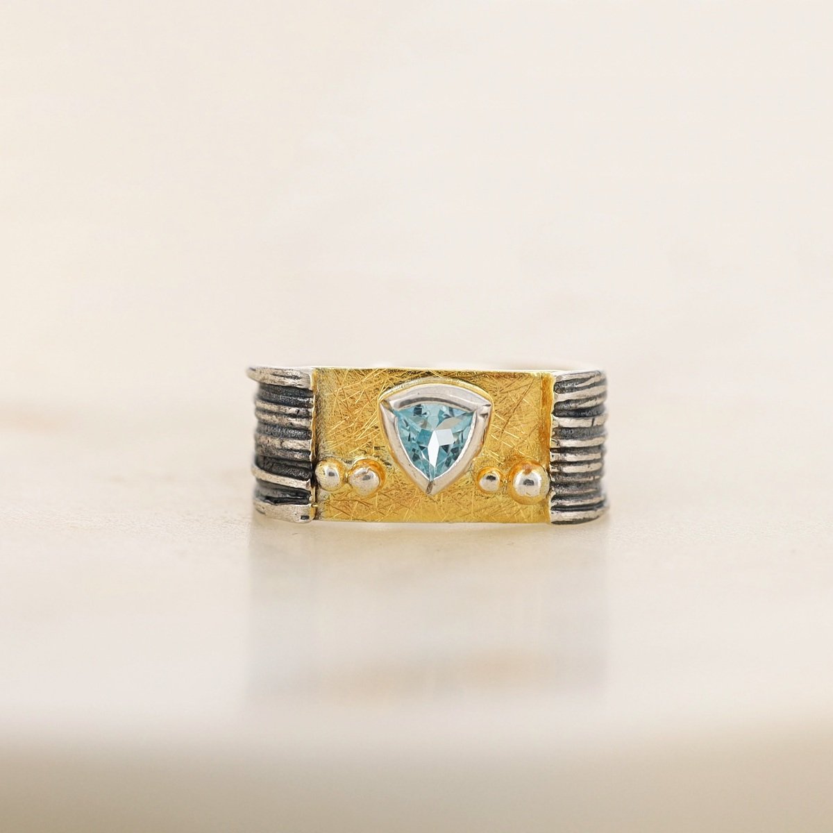 oxidized textured sterling silver gold plate trillion blue topaz wide band ring