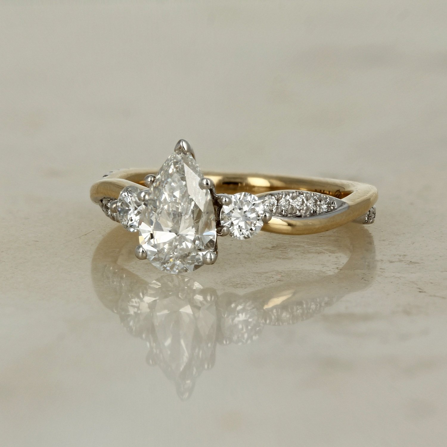 14k two tone yellow and white gold lab diamond pear shaped twisted infinity band engagement ring